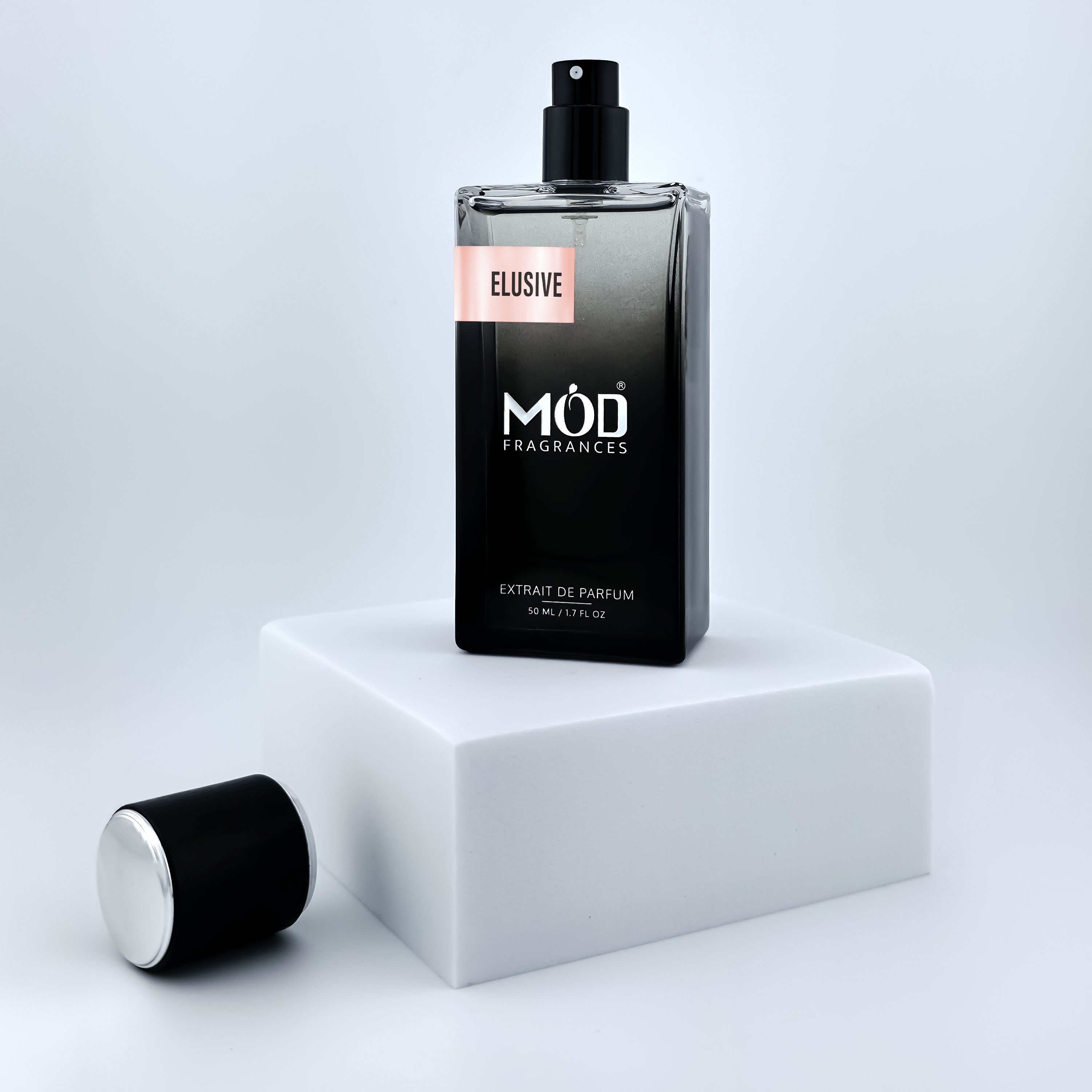Black perfume bottle labeled 'MOD Fragrances' on a white platform with a light gray background