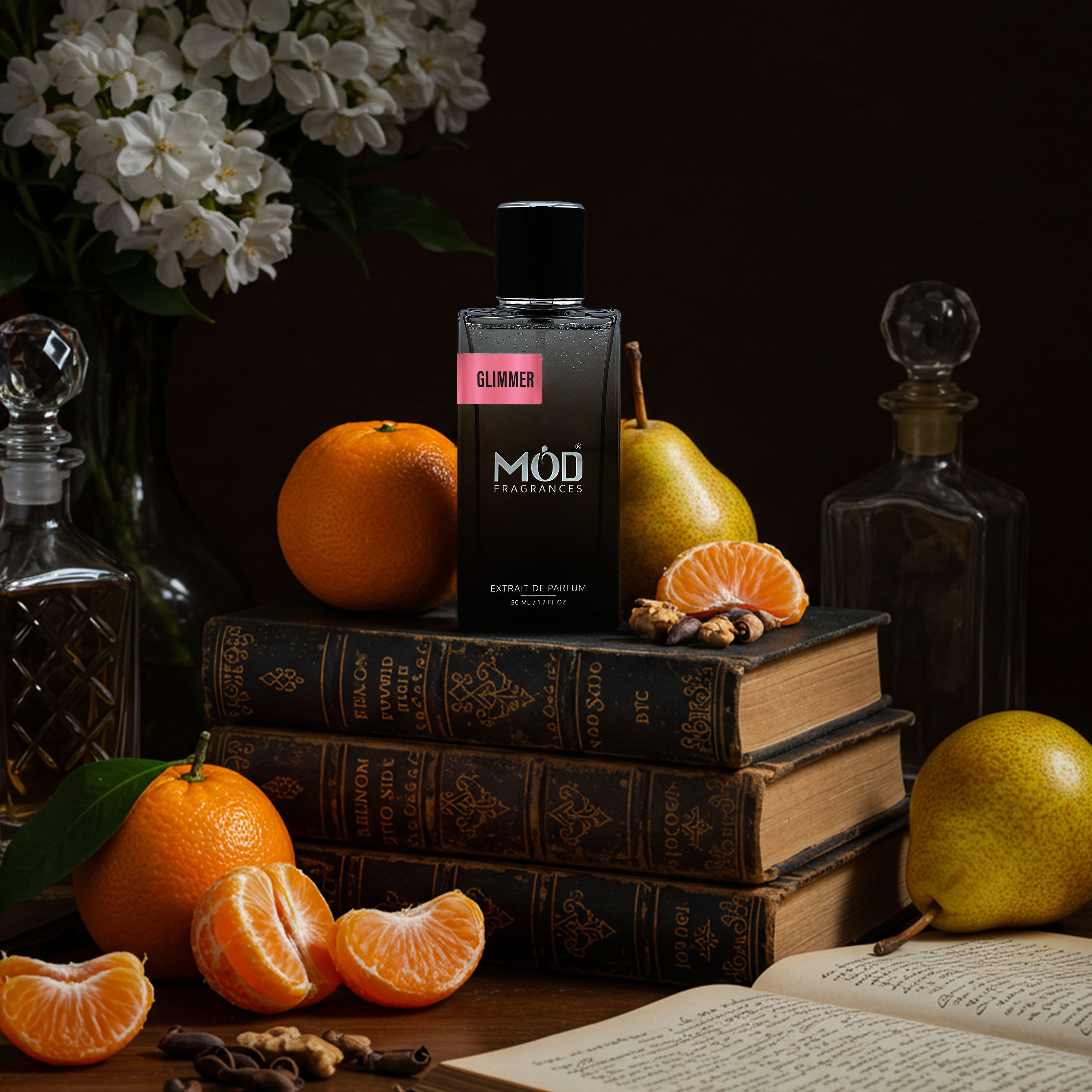 Möd Glimmer perfume bottle on books with fruits and flowers