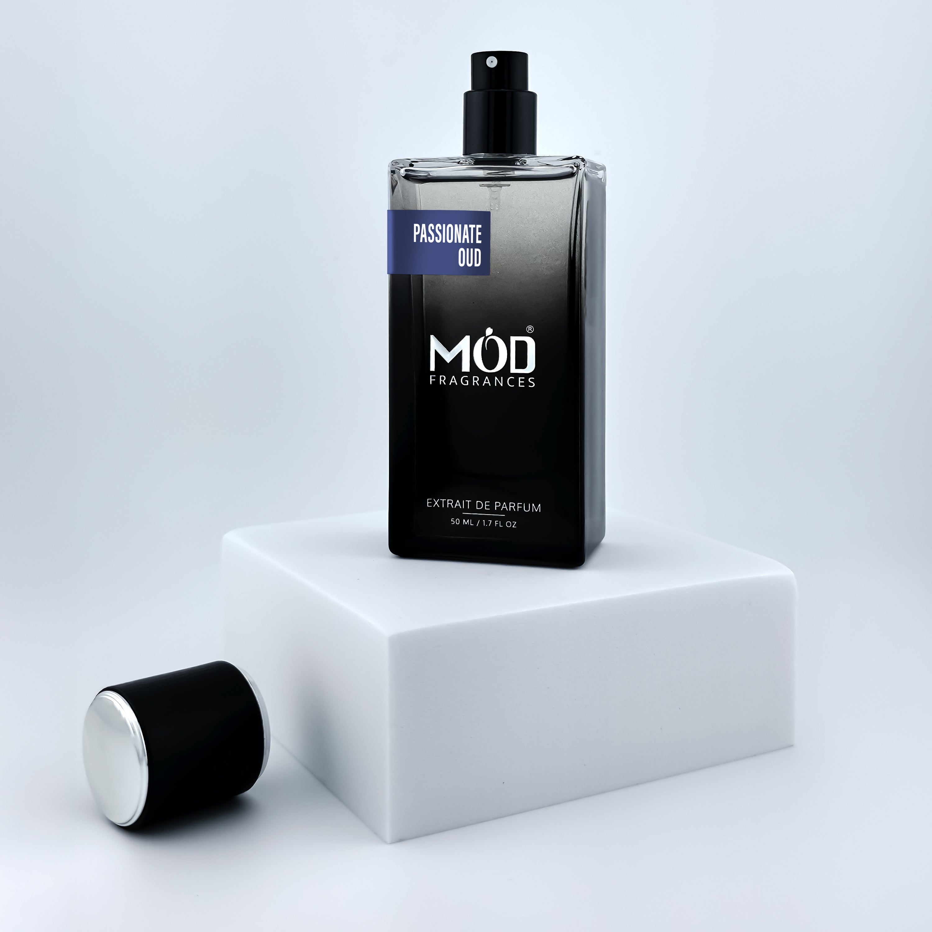 Oud Maracuja Dupe Perfume bottle labeled 'MOD Fragrances' on a white platform with a light gray background