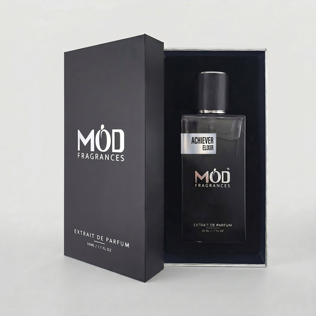 An open premium black perfume box reveals a rectangular glass bottle labeled “Achiever Elixir” by MOD Fragrances, resting securely in a black-lined presentation case.