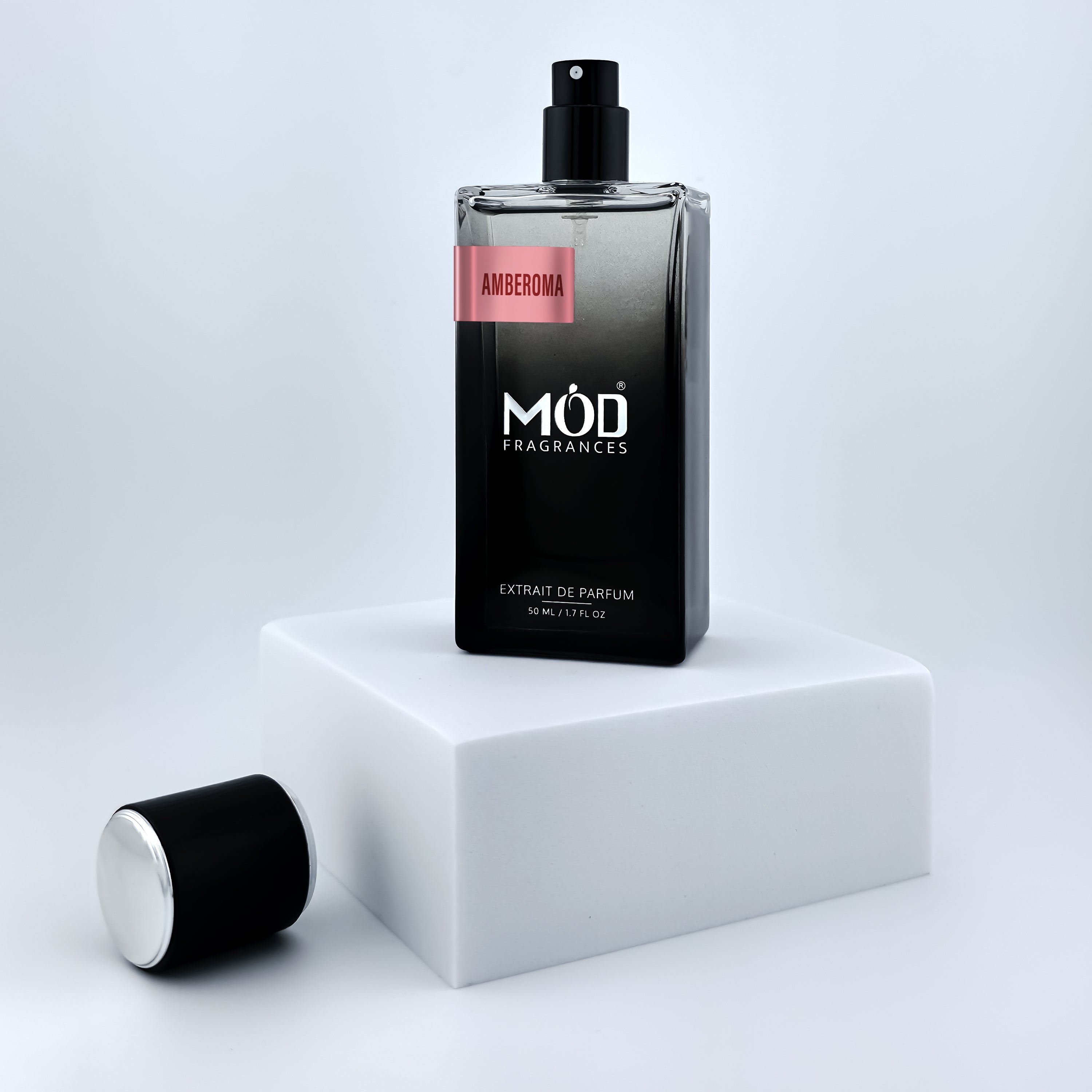Perfume bottle labeled 'Möd Fragrances' on a white platform with a light gray background