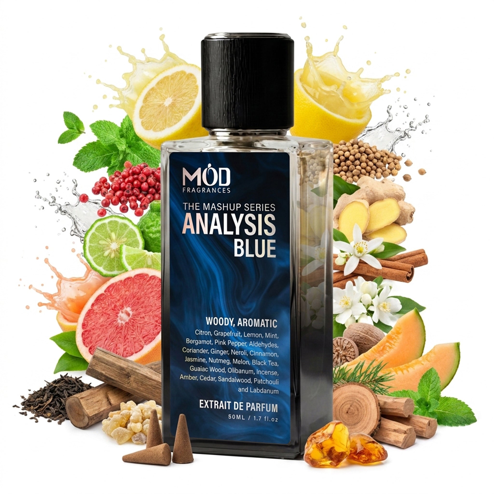 A glass perfume bottle by MOD Fragrances, labeled "mashup series Analysis Blue" is surrounded by a vibrant artistic arrangement of its fragrance ingredients, including mandarin, grapefruit, lemon, bergamot, black tea, mint leaves, ginger, citrus fruits, cinnamon sticks, orange slices, and tea, against a white background.