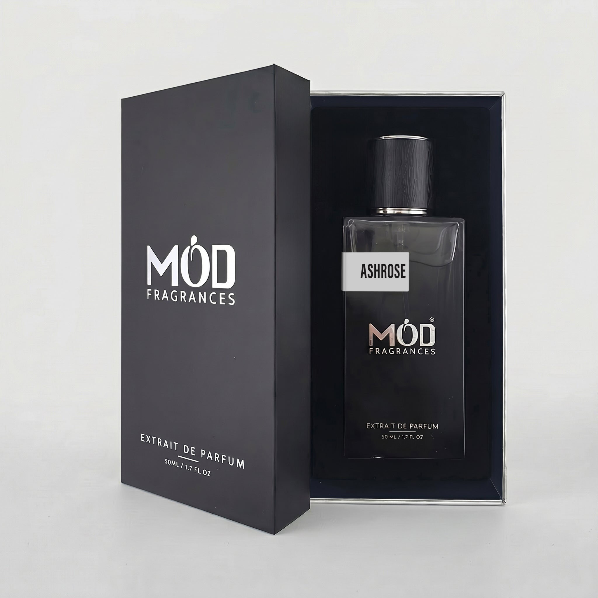 An open premium black perfume box reveals a rectangular glass bottle labeled “AshRose” by MOD Fragrances, resting securely in a black-lined presentation case.