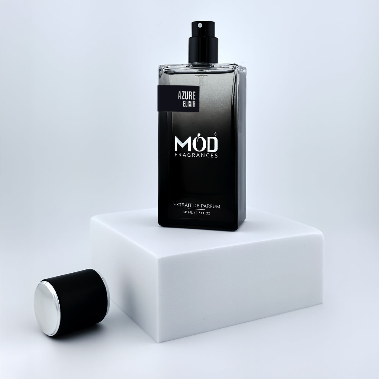 Black perfume bottle with 'Möd Fragrances' branding on a white platform.