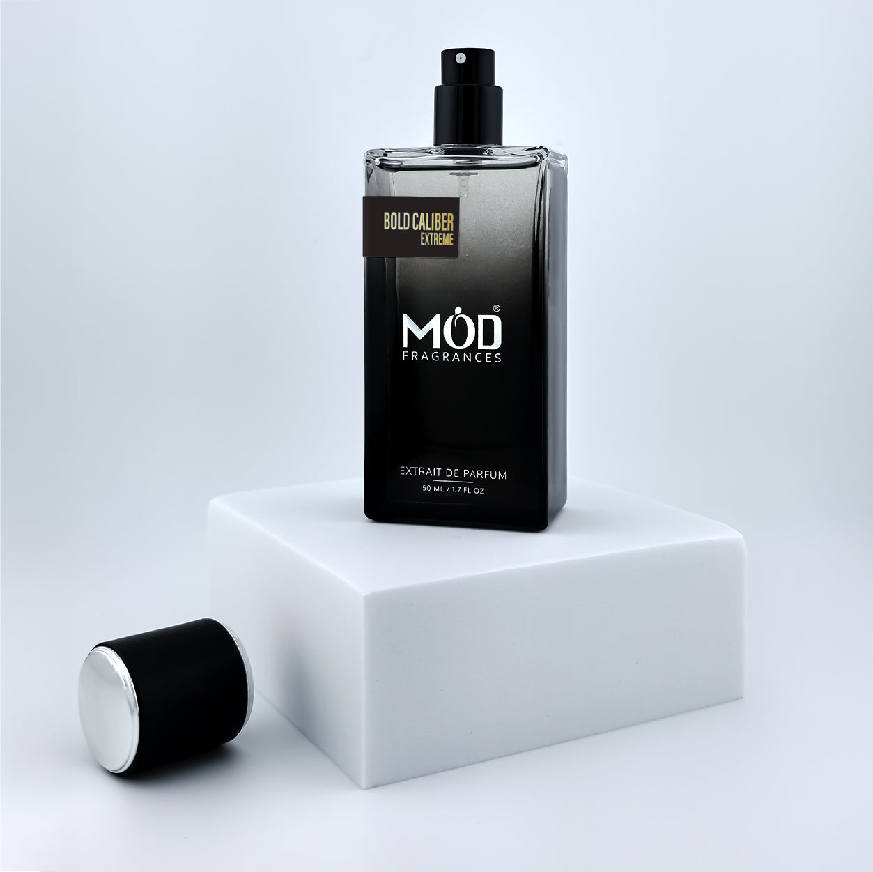 Inspire by Homme EDT Black perfume bottle with 'MOD Fragrances' branding on a white platform.