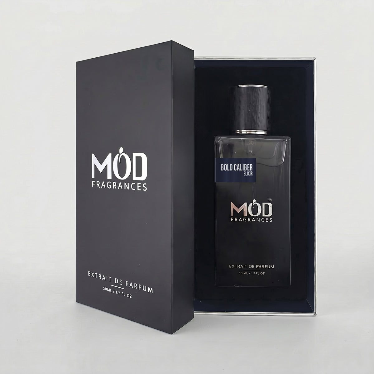 An open premium black perfume box reveals a rectangular glass bottle labeled “Bold Caliber Elixir” by MOD Fragrances, resting securely in a black-lined presentation case.