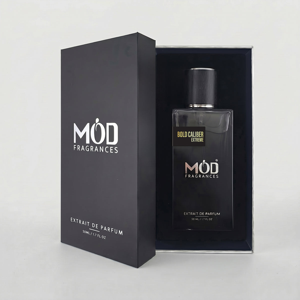 An open premium black perfume box reveals a rectangular glass bottle labeled “Bold Caliber Extreme” by MOD Fragrances, resting securely in a black-lined presentation case.