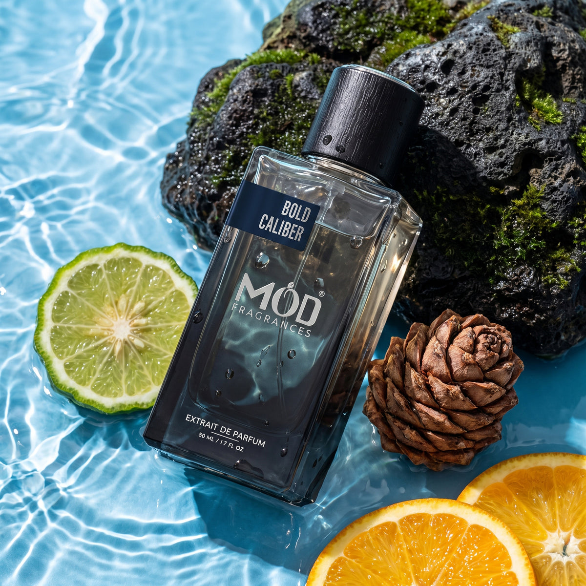 A rectangular glass perfume bottle by MOD Fragrances, labeled "Bold Caliber” is laying, resting on moss stone at the edge of freshwater spring, surrounded by its ingredients like calabrian orange, bergamot and sedar cone, highlighting bottle and its ingredients. 
