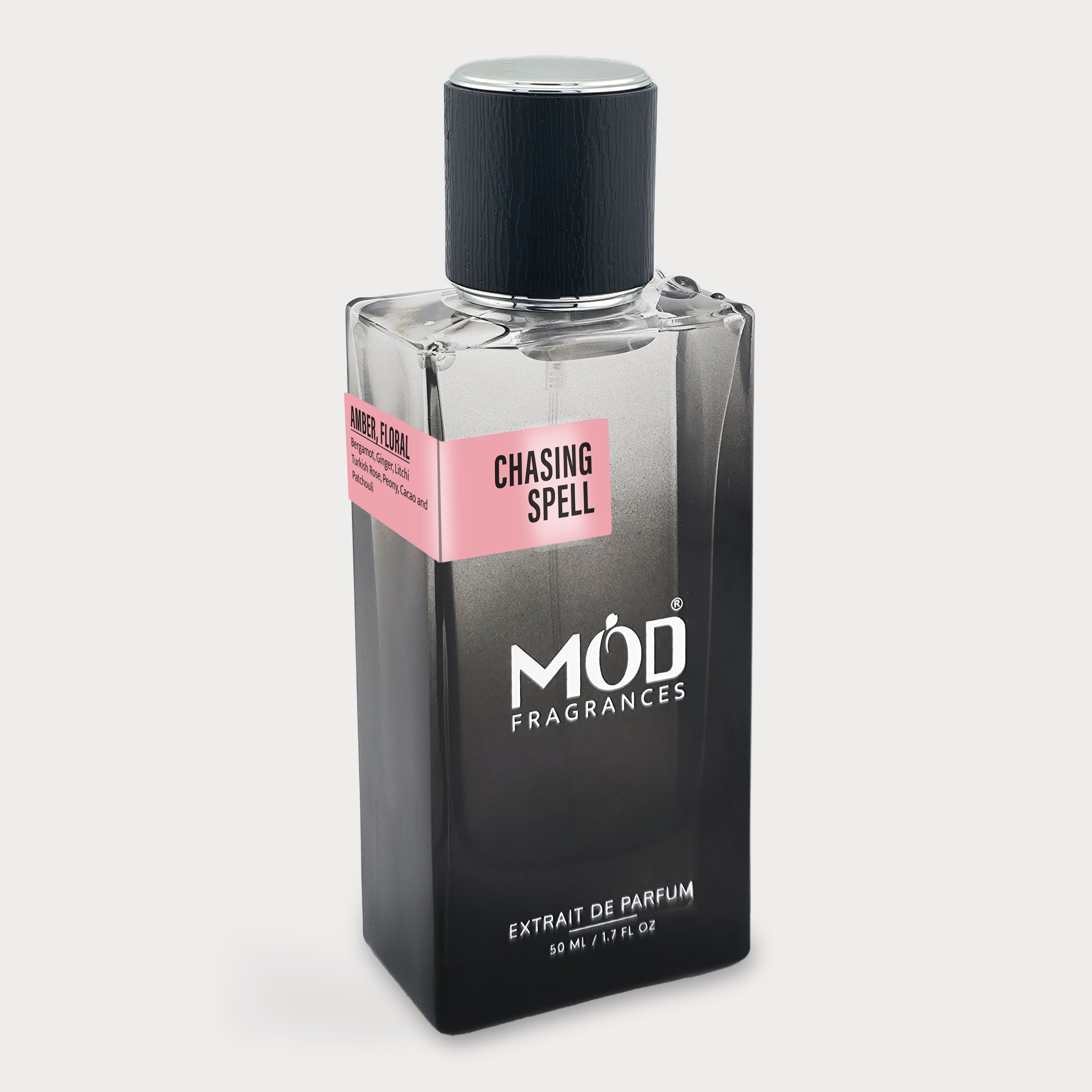 Perfume bottle labeled 'Chasing Spell' by MOD Fragrances on a light gray background