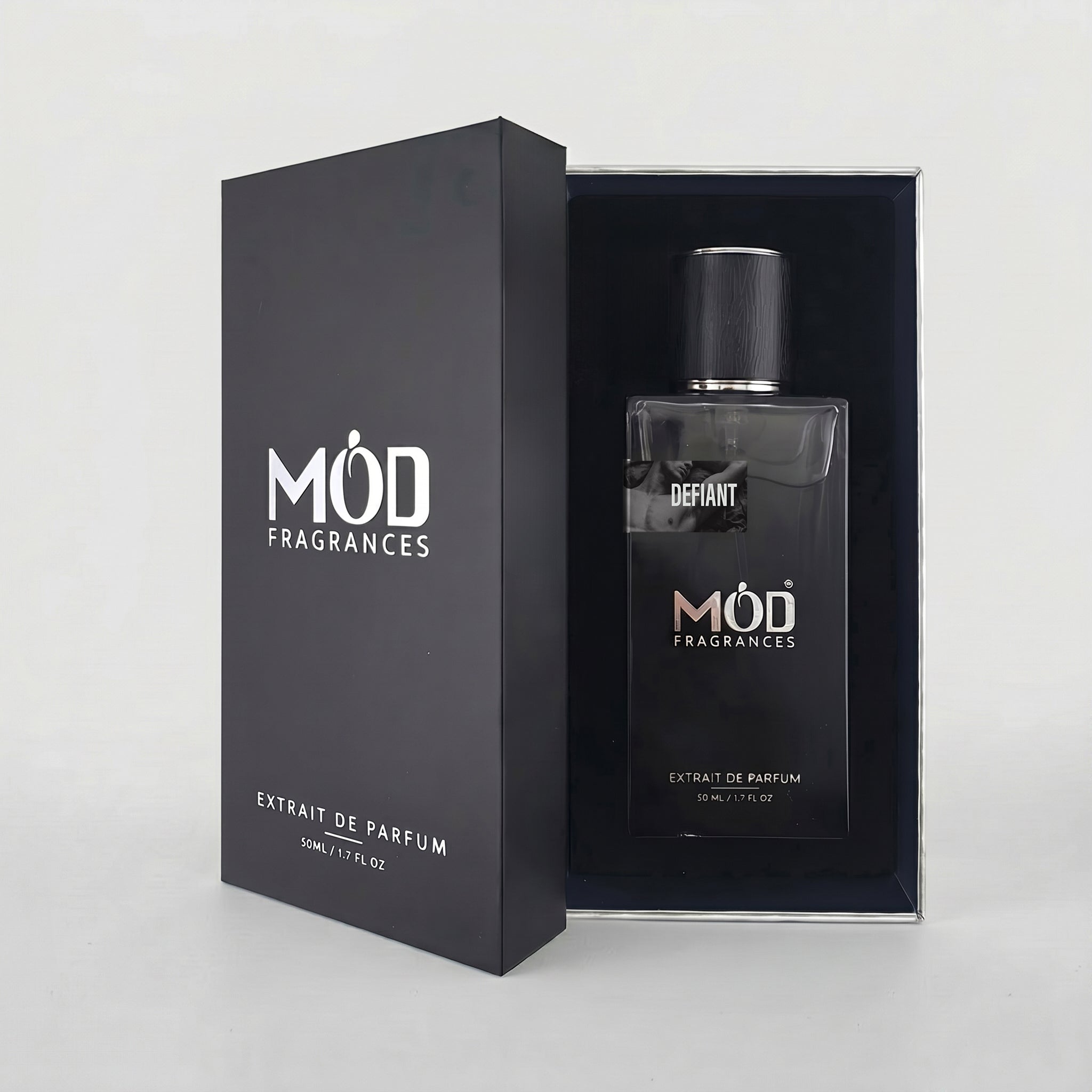 A bottle of MOD FRAGRANCES Achiever Absolu Extrait de Parfum next to its black presentation box, set against a clean light gray background.