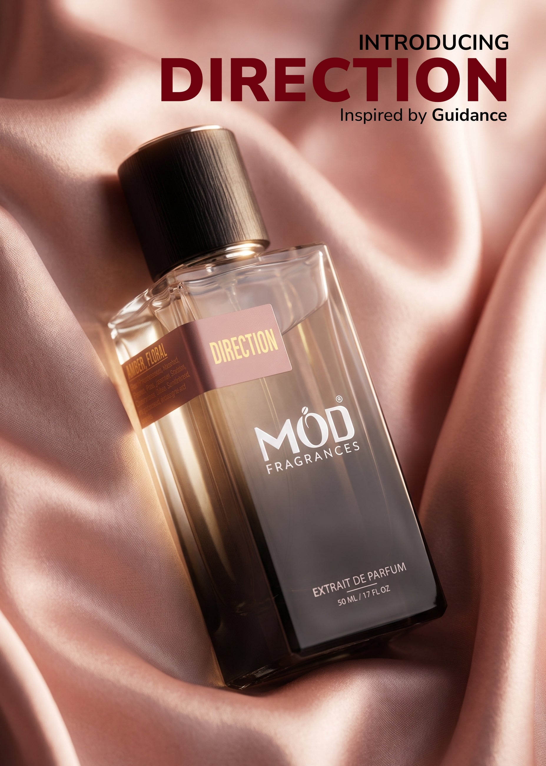 Perfume bottle labeled 'MOD Fragrances' on a pink fabric background with text 'Introducing Direction Inspired by Guidance'.