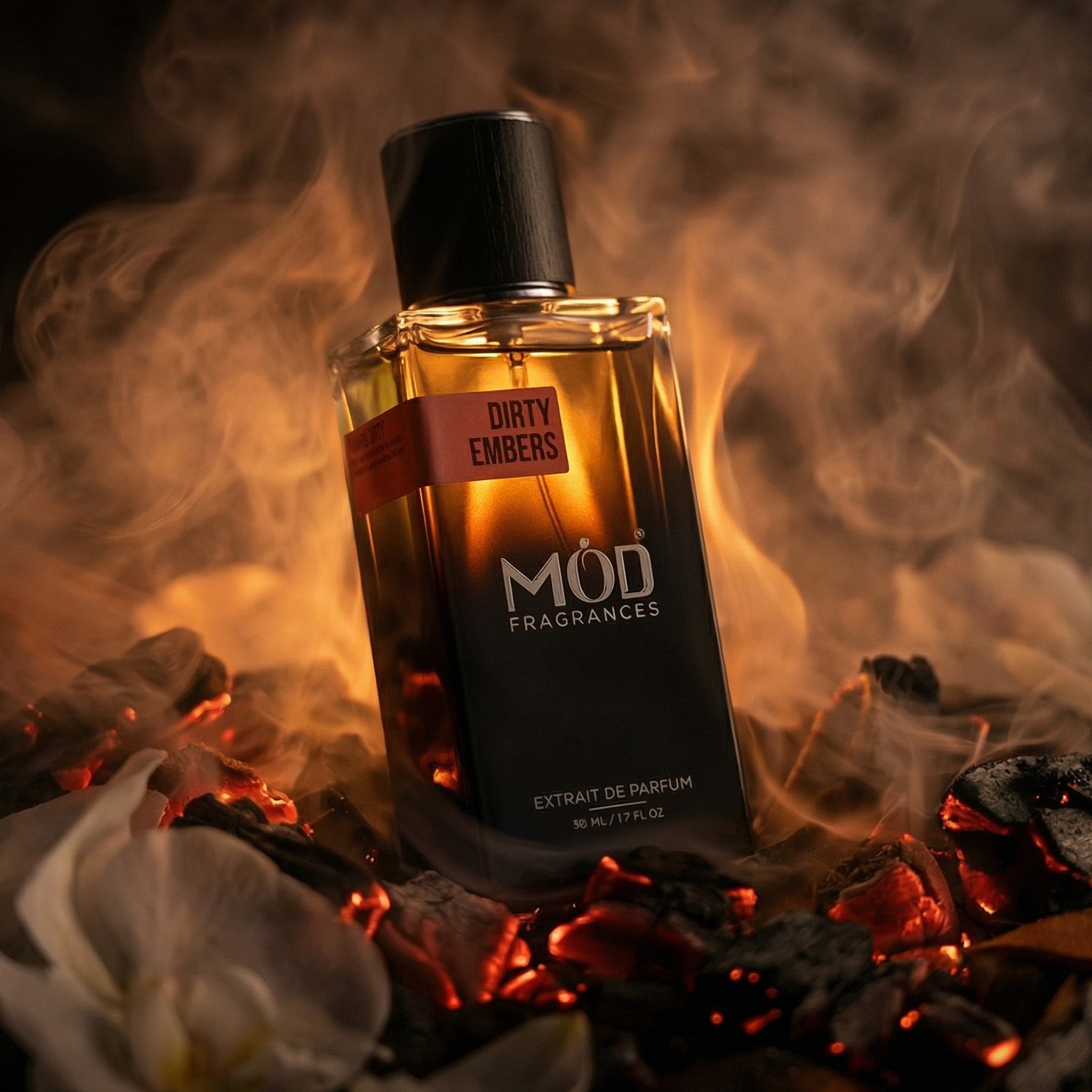 Perfume bottle labeled 'DIRTY EMBERS' by MOD FRAGRANCES with flames and embers in the background
