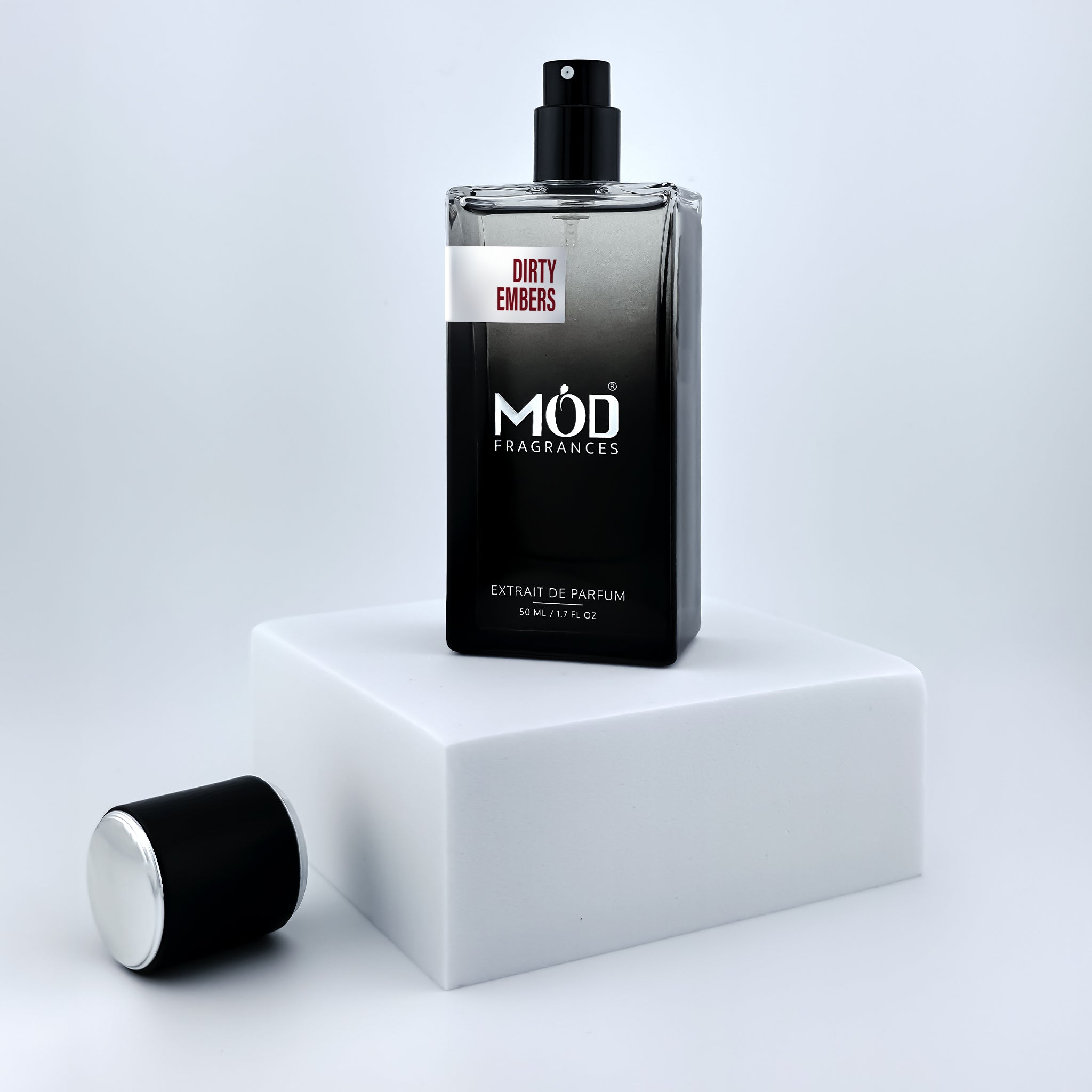 Perfume bottle labeled 'MÖD Fragrances' on a white platform with a light gray background