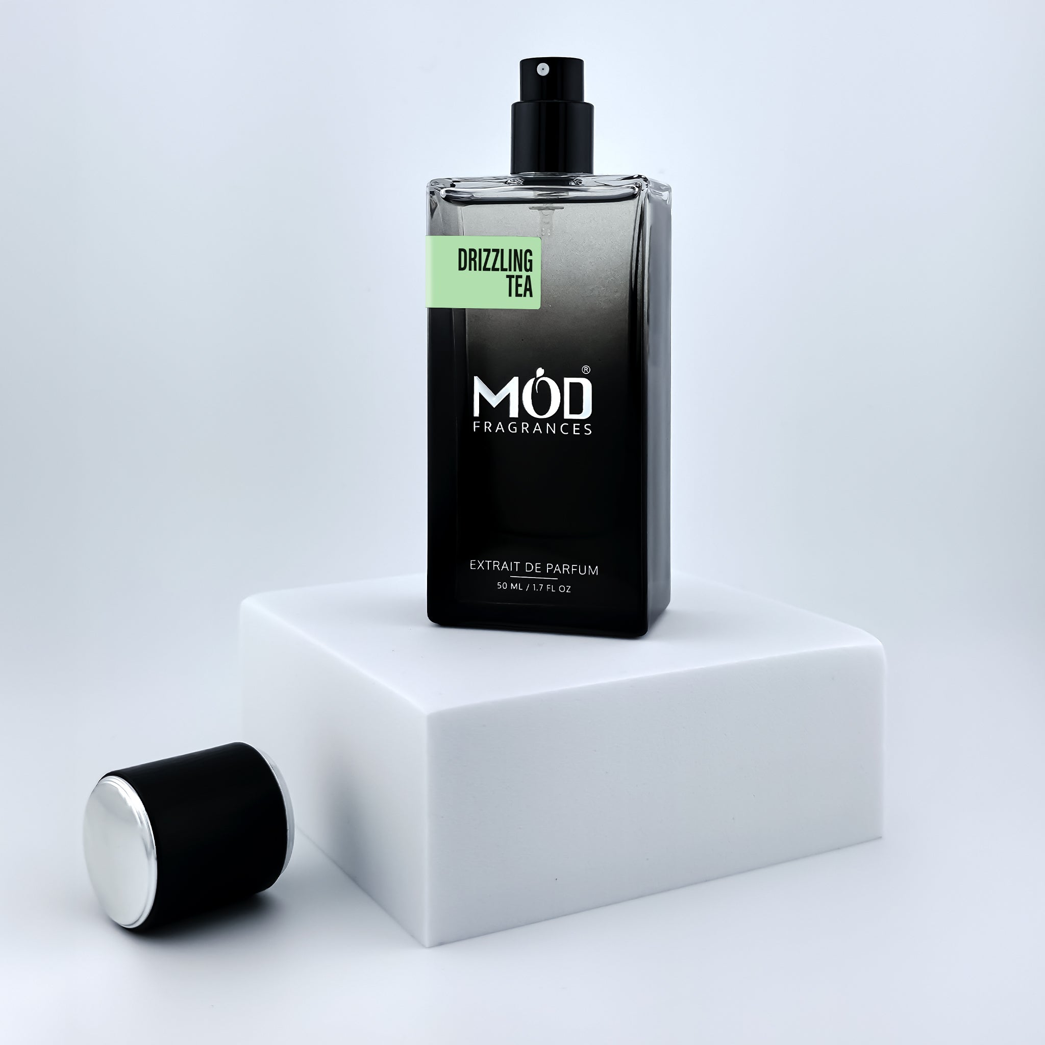 Black perfume bottle with 'Möd Fragrances' on a white platform