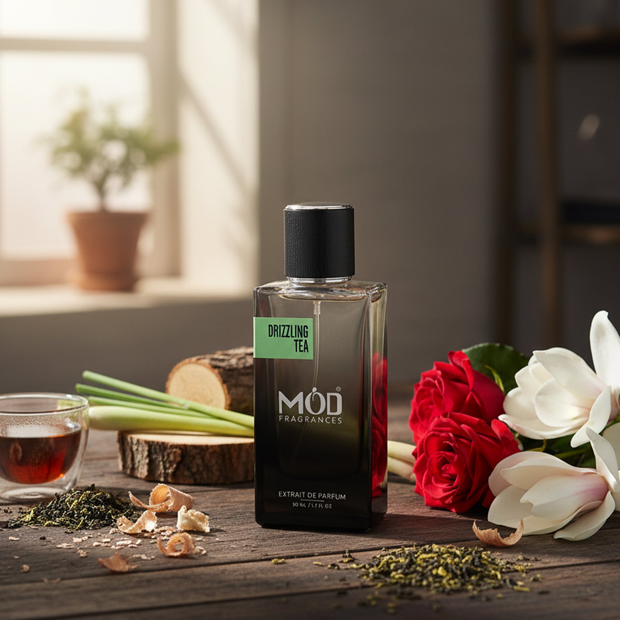MOD Fragrances bottle on a wooden table with flowers and tea leaves
