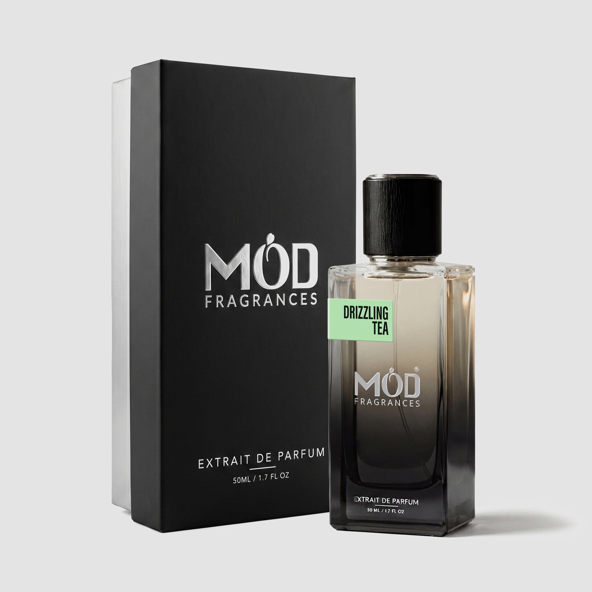 MOD Fragrances 50ml perfume bottle and premium box of "drizzling Tea" fresh fragrance for him & her, inspired by Rain Tea, placed vertically on white background.