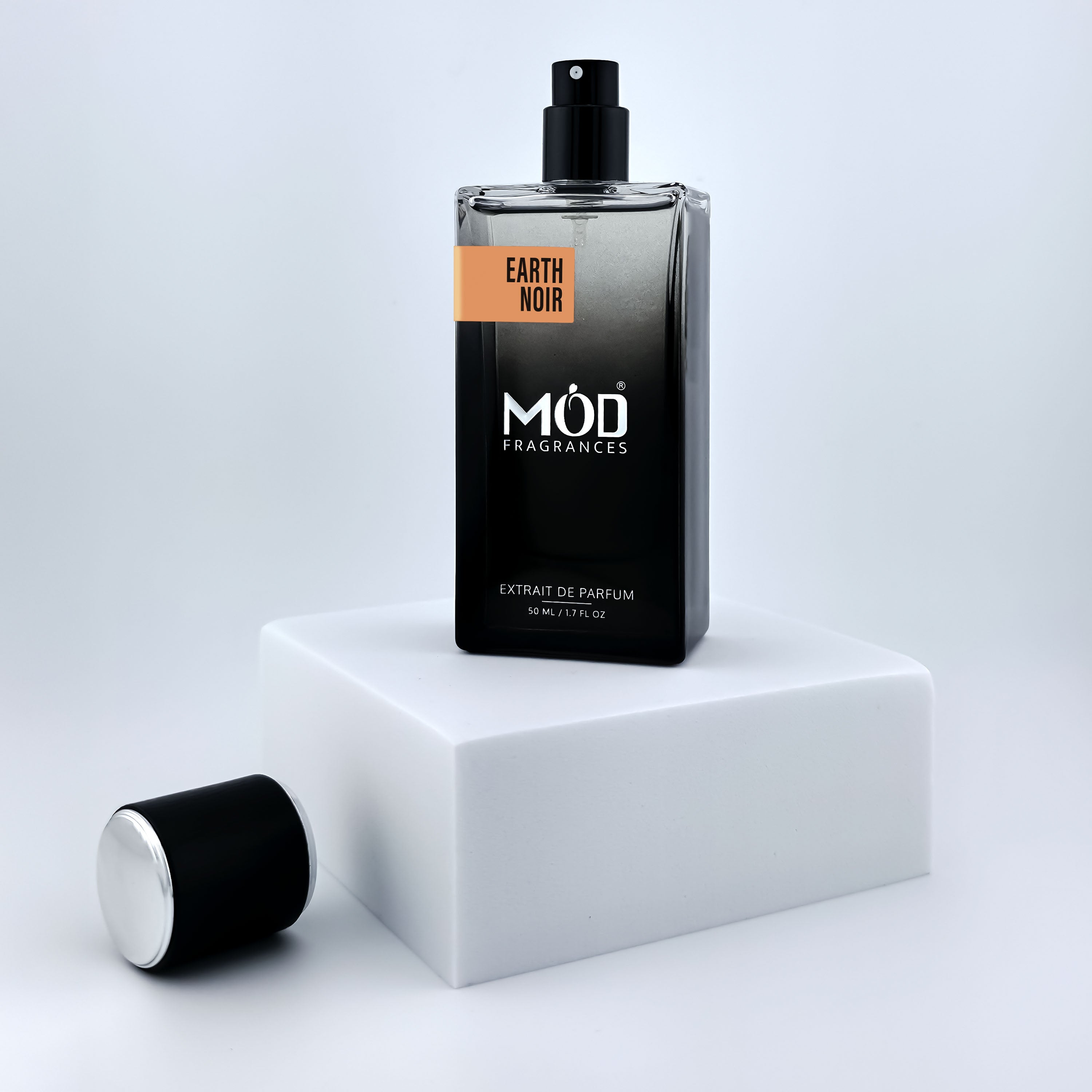Perfume bottle labeled 'MOD Fragrances' on a white platform with a light gray background