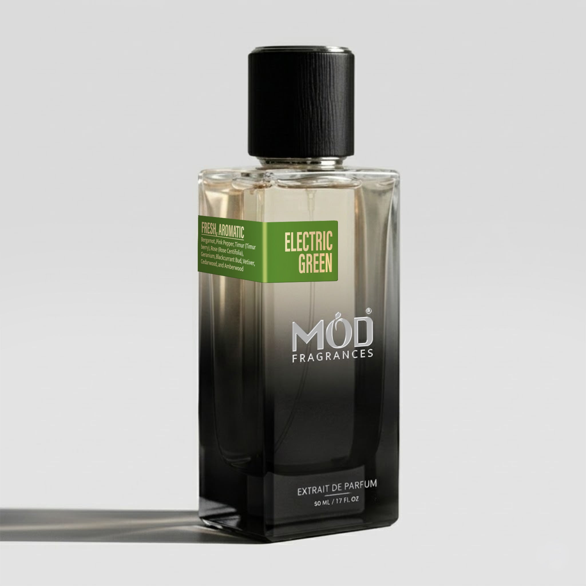 Perfume bottle labeled 'Electric Green' by Möd Fragrances on a gray background