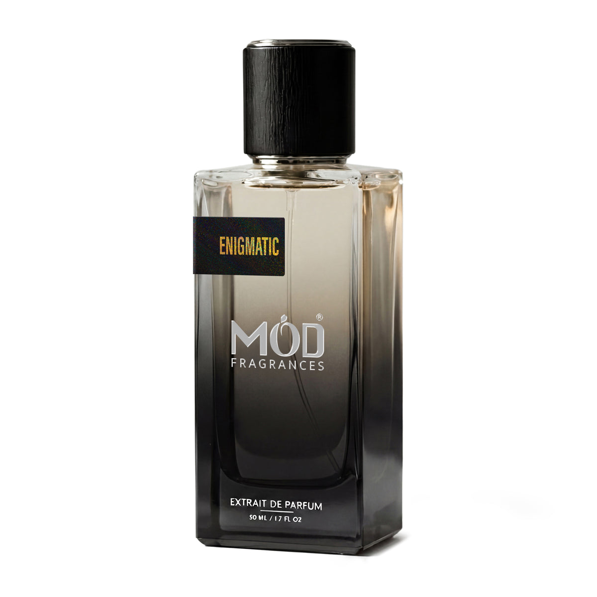 A rectangular glass perfume bottle by MOD Fragrances, labeled “Enigmatic” stands centered against a plain white background, featuring a black cap and a gradient black-to-clear glass finish.