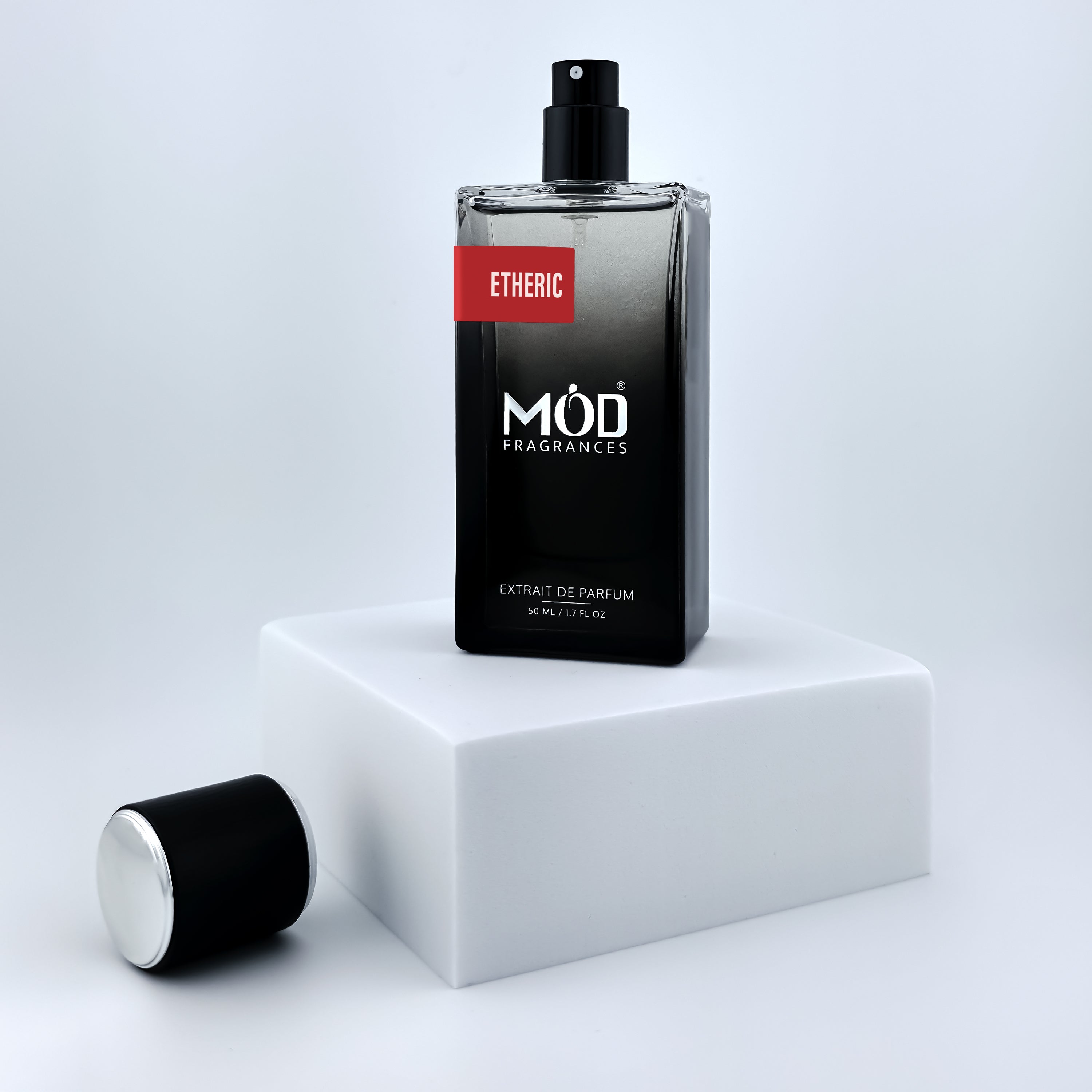 Perfume bottle labeled 'Möd Fragrances' on a white platform with a light gray background