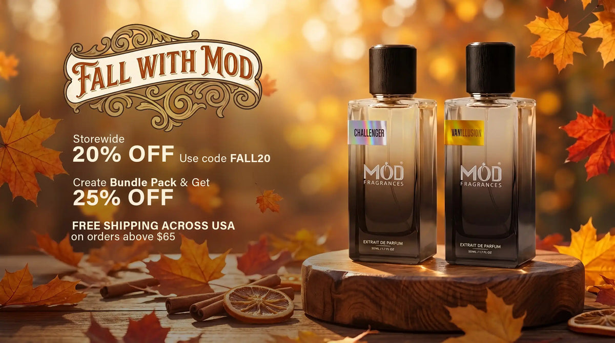 Two MOD Fragrances perfume bottles displayed on a wooden stand, surrounded by autumn leaves and warm bokeh background, with promotional text on the left reading 'Fall With Mod'.