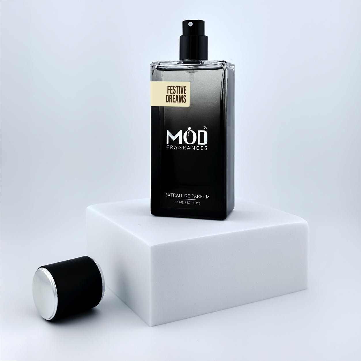 Perfume bottle labeled 'MOD Fragrances' on a white platform with a light gray background