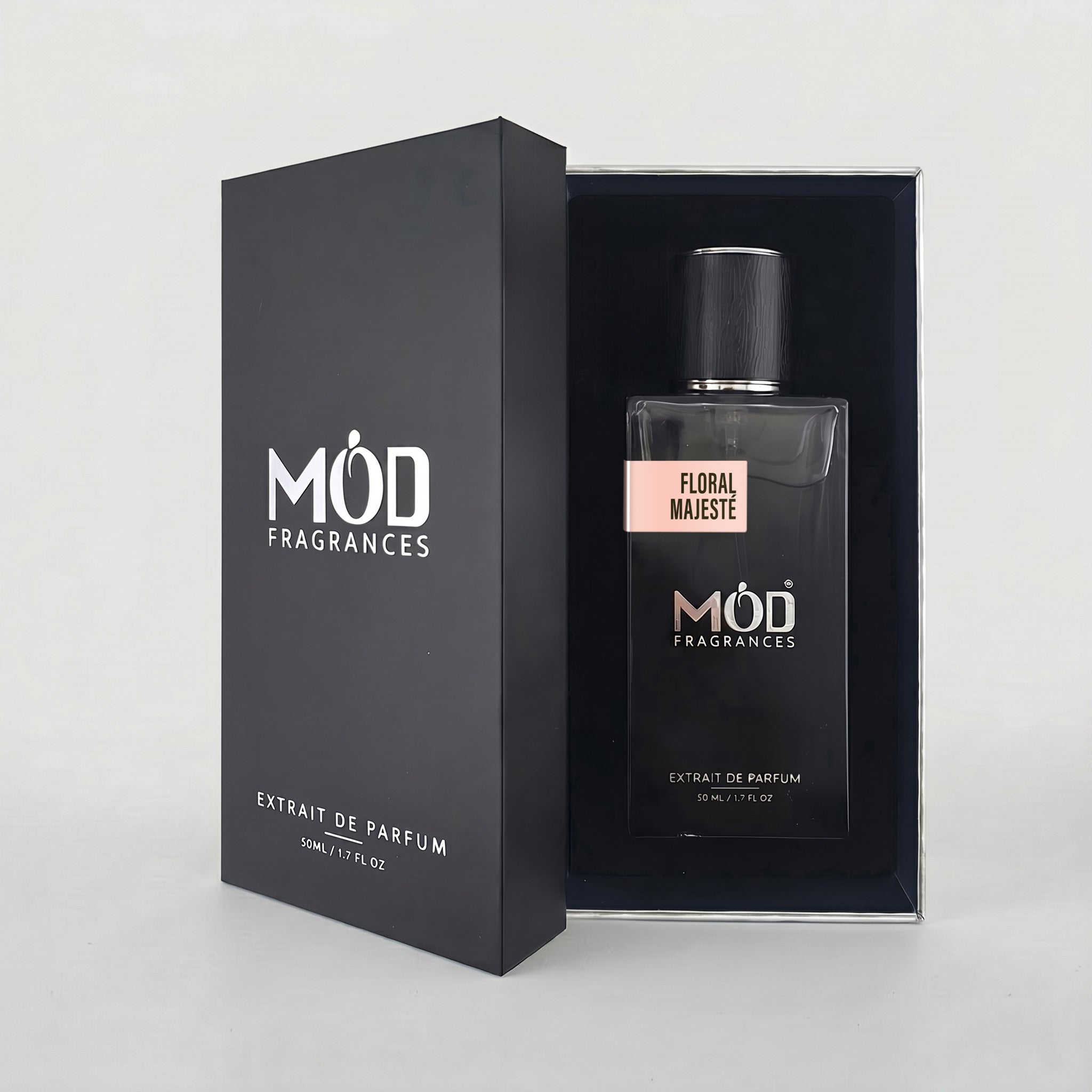 An open premium black perfume box reveals a rectangular glass bottle labeled “Floral Majeste” by MOD Fragrances, resting securely in a black-lined presentation case.