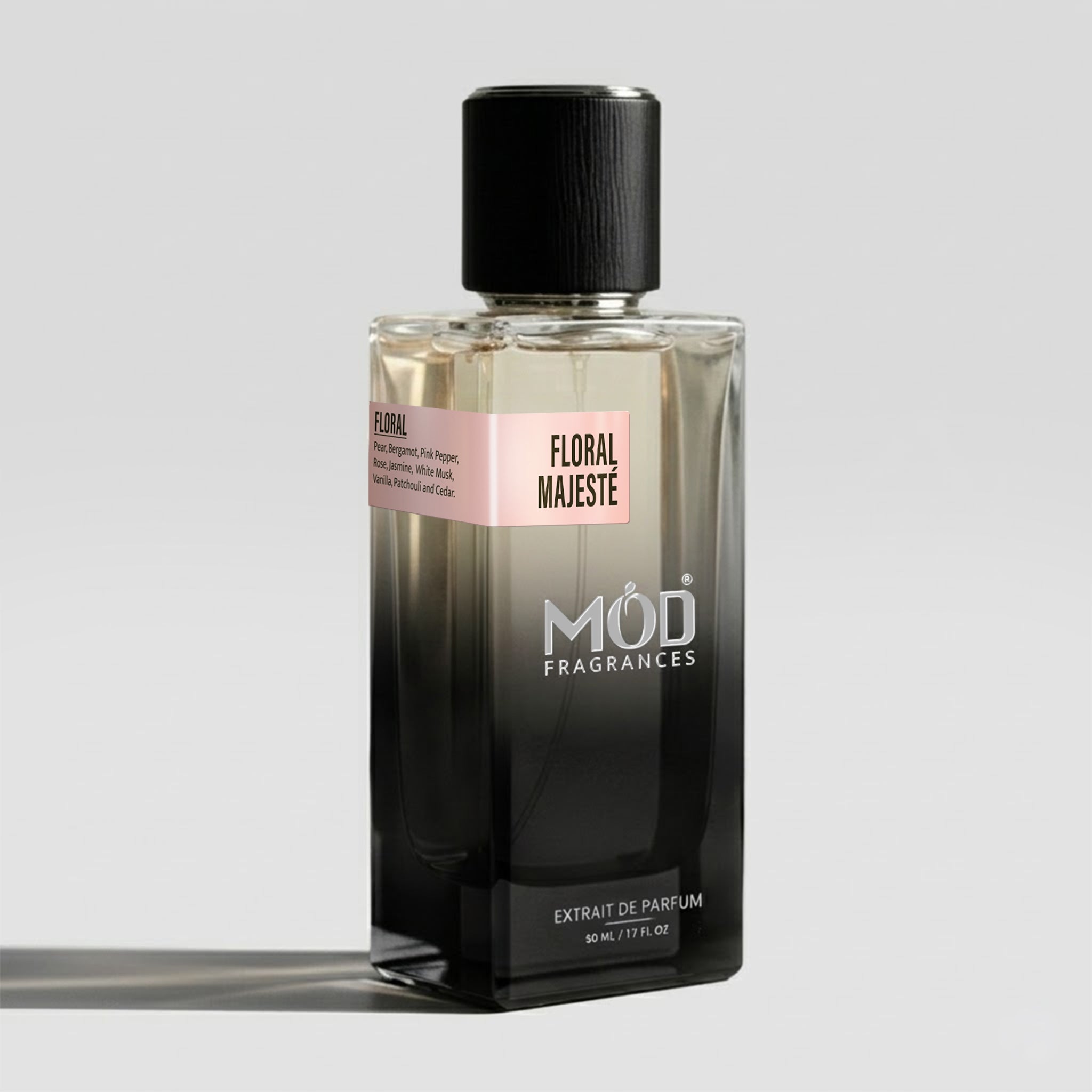 A rectangular glass perfume bottle by MOD Fragrances, labeled “Floral Majeste” with a small label detailing its notes, stands on a light background. 