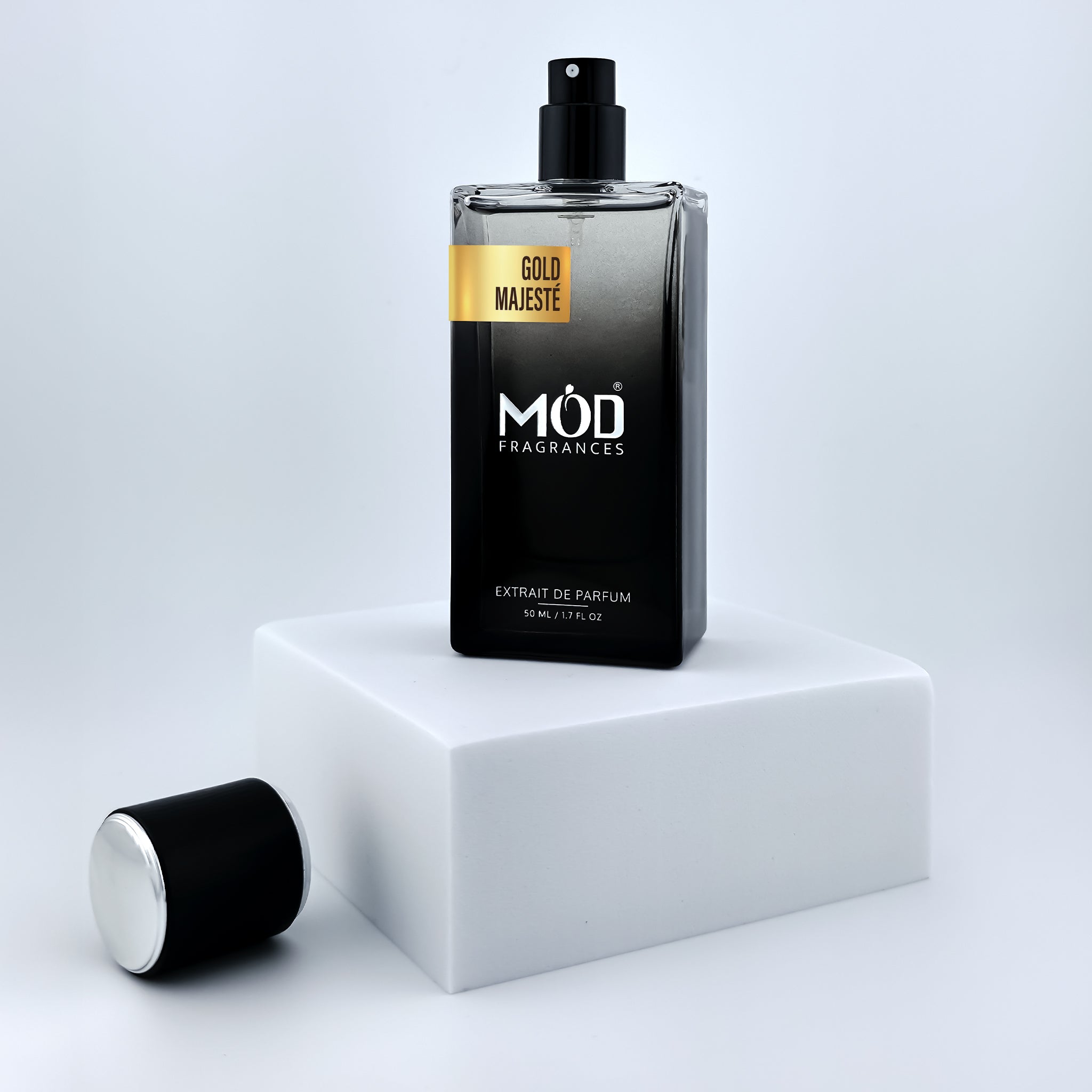Black perfume bottle with 'Möd Fragrances' on a white platform