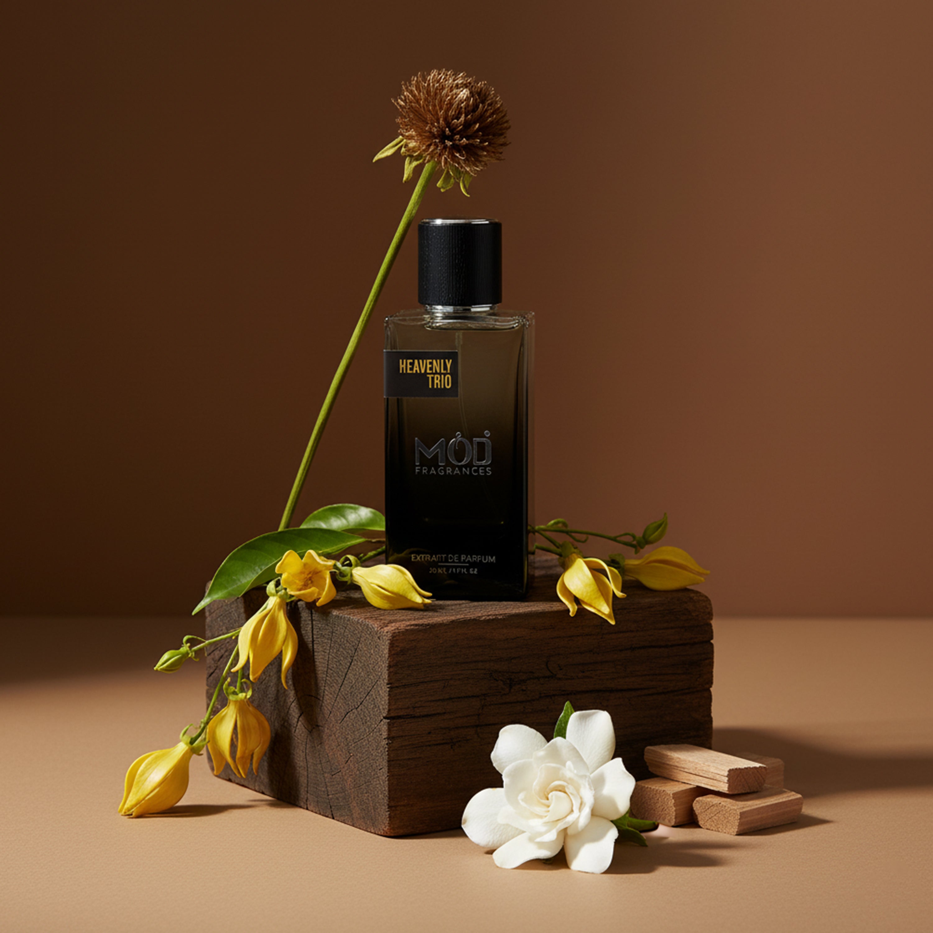 Perfume bottle labeled 'MOU' with flowers on a wooden block against a brown background