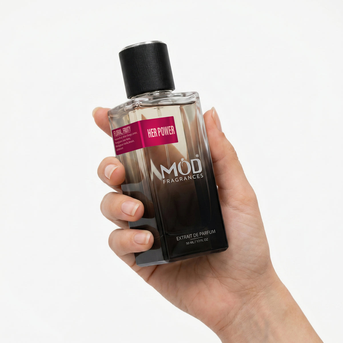 A hand holding a bottle of MOD FRAGRANCES 'Her Power' Extrait de Parfum against a clean white background.