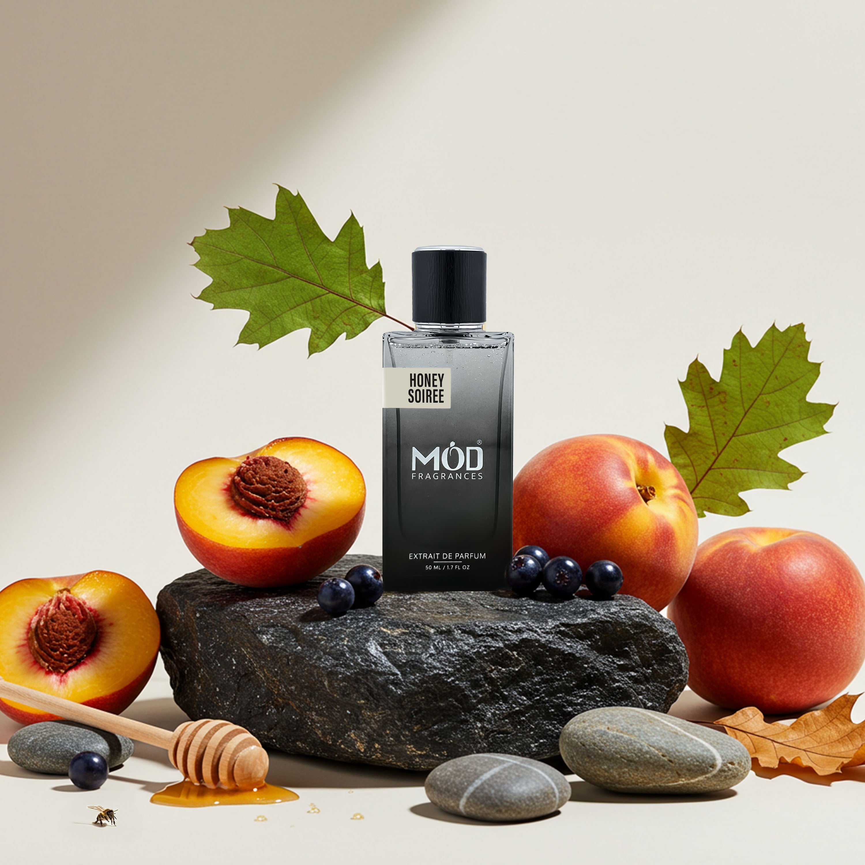 Perfume bottle labeled 'Méd' with peaches and leaves on a stone surface