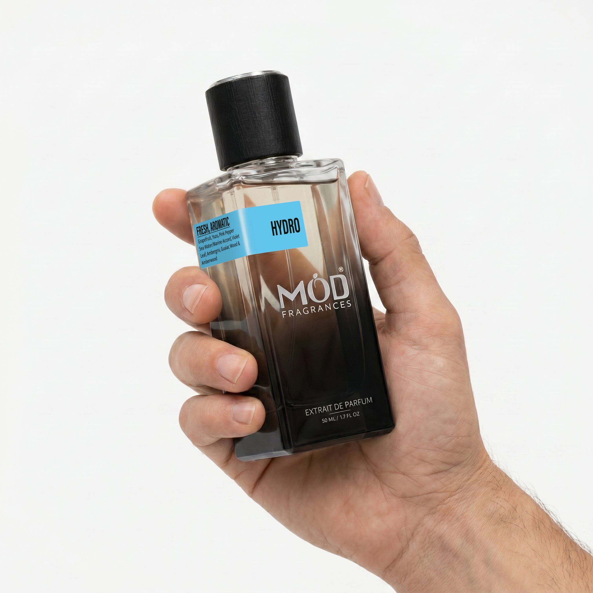 MOD Fragrances 50ml, premium perfume bottle of "Hydro" fresh & aromatic fragrance for men, inspired by "Invictus Aqua", holding by a man's hand, on white background.