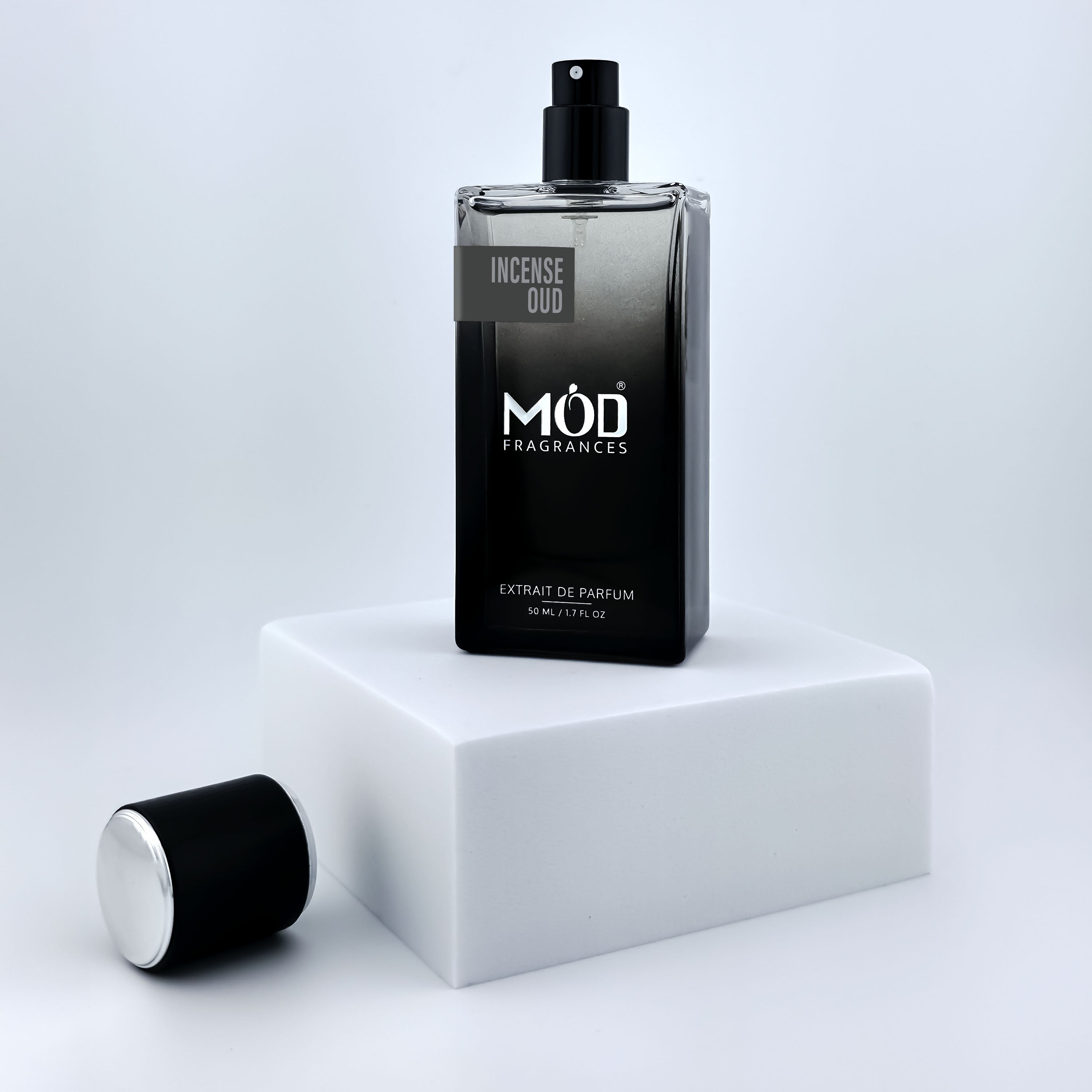 Black perfume bottle with 'MOD Fragrances' branding on a white platform.