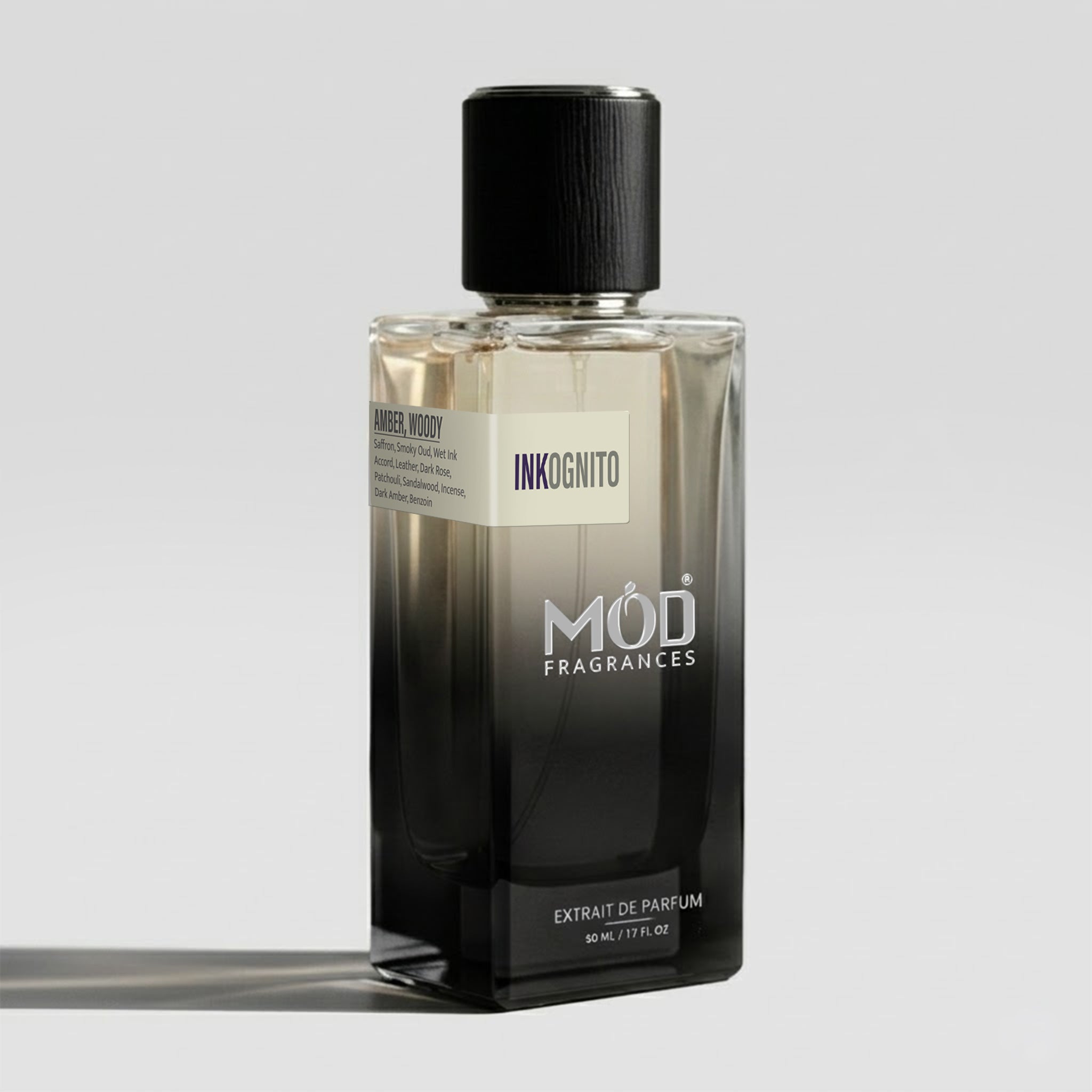 Perfume bottle labeled 'Forbidden Spirits' by MOD Fragrances on a gray background