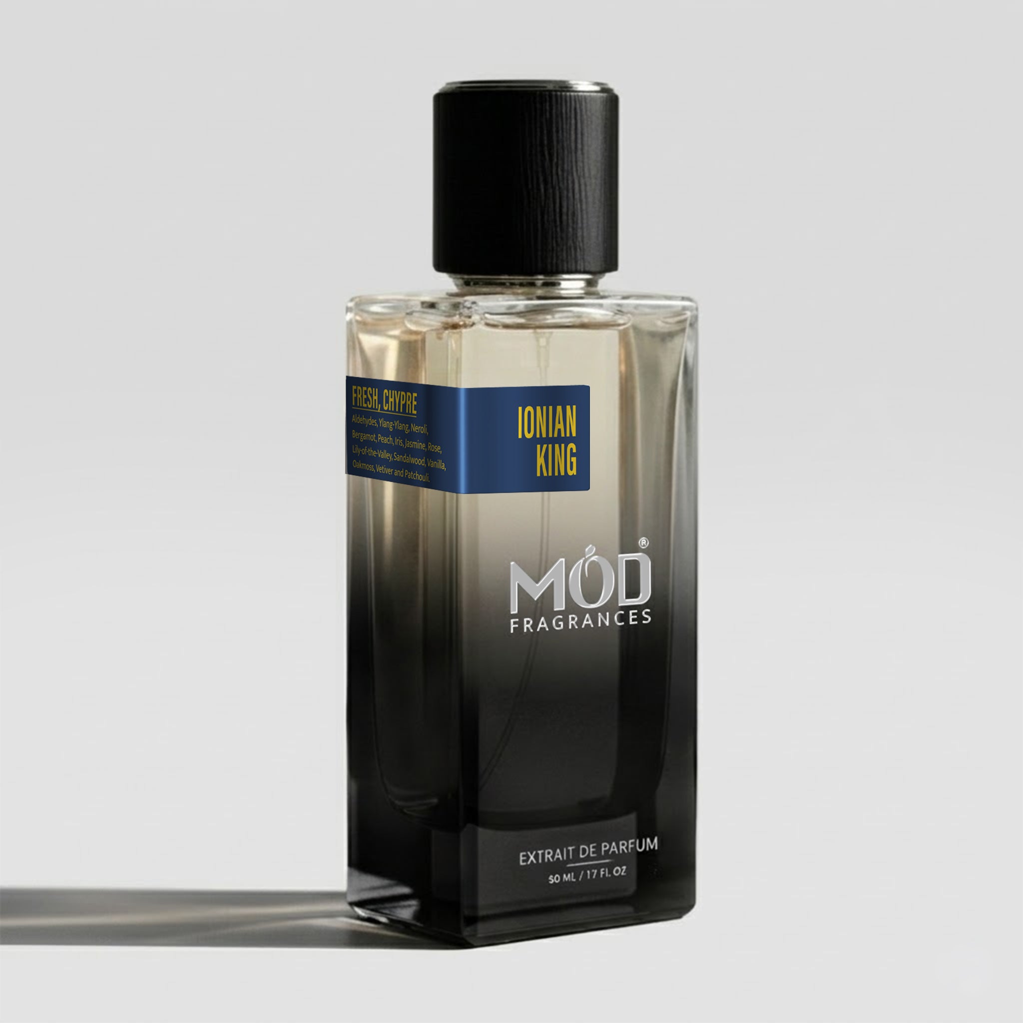 A rectangular glass perfume bottle by MOD Fragrances, labeled "Ionian King" with a small label detailing its leather, woody notes, stands on a light background.