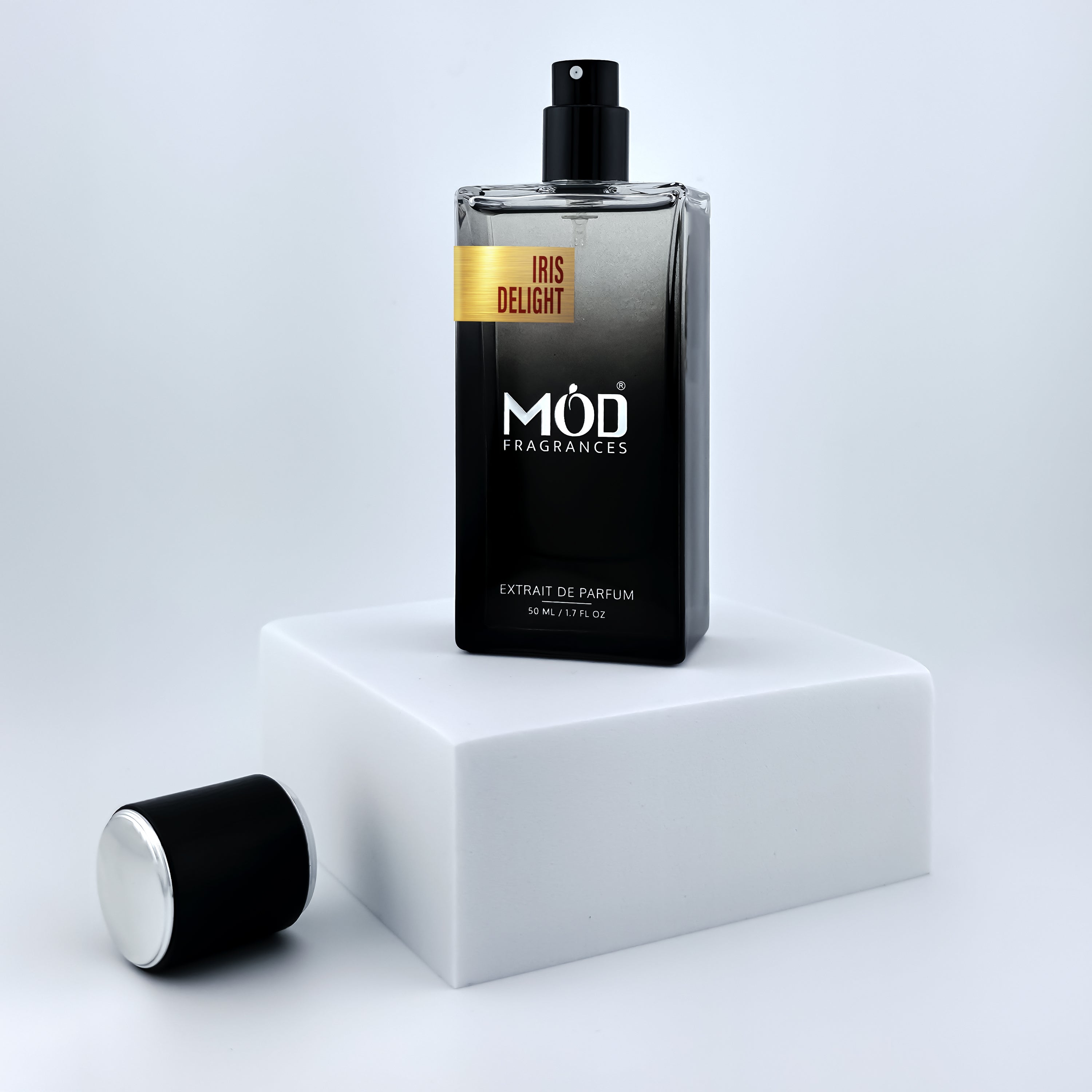 Perfume bottle labeled 'Man of Gold' by MOD Fragrances on a white platform with a light gray background
