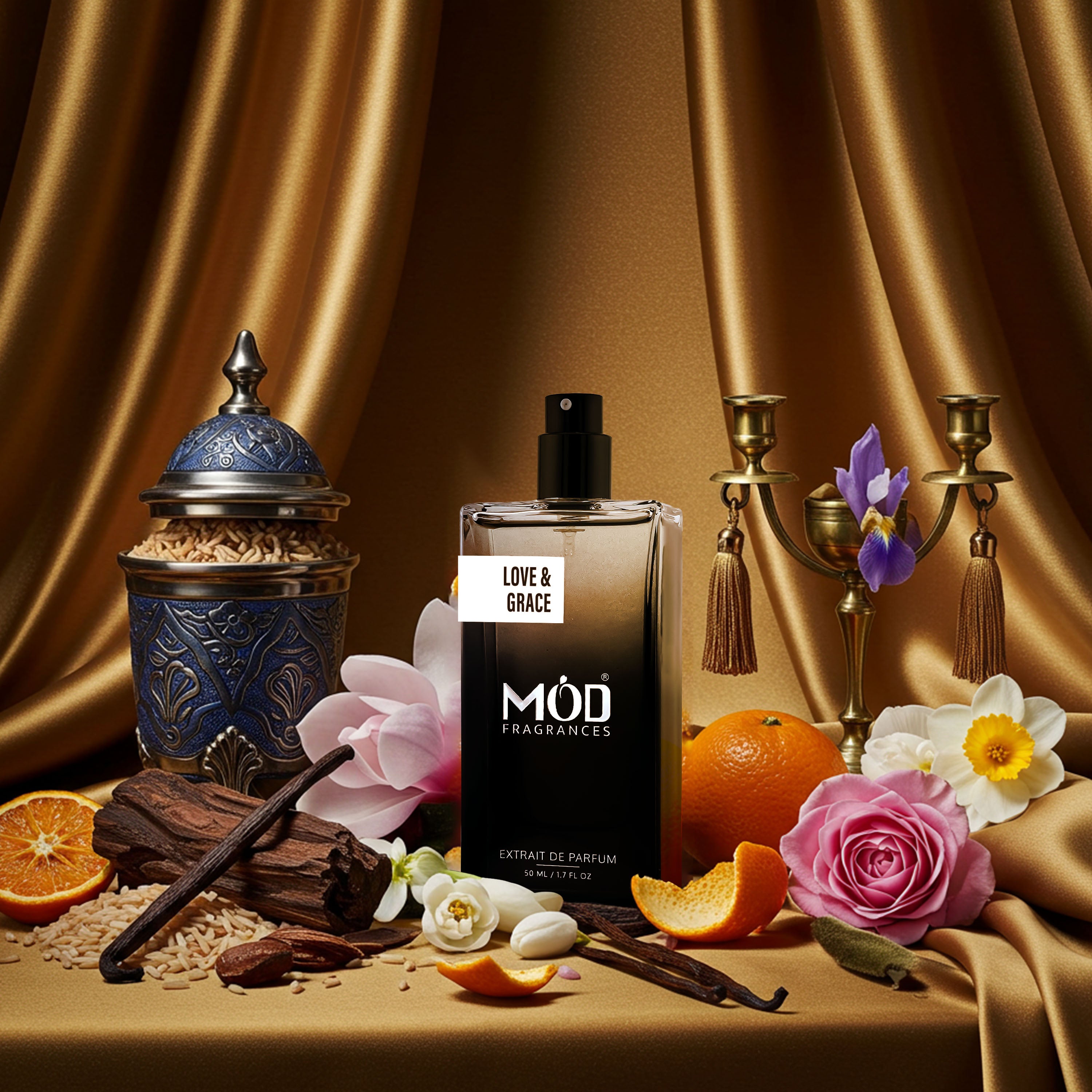 MOD Fragrances Love & Grace perfume bottle with flowers, oranges, and candles on a brown background