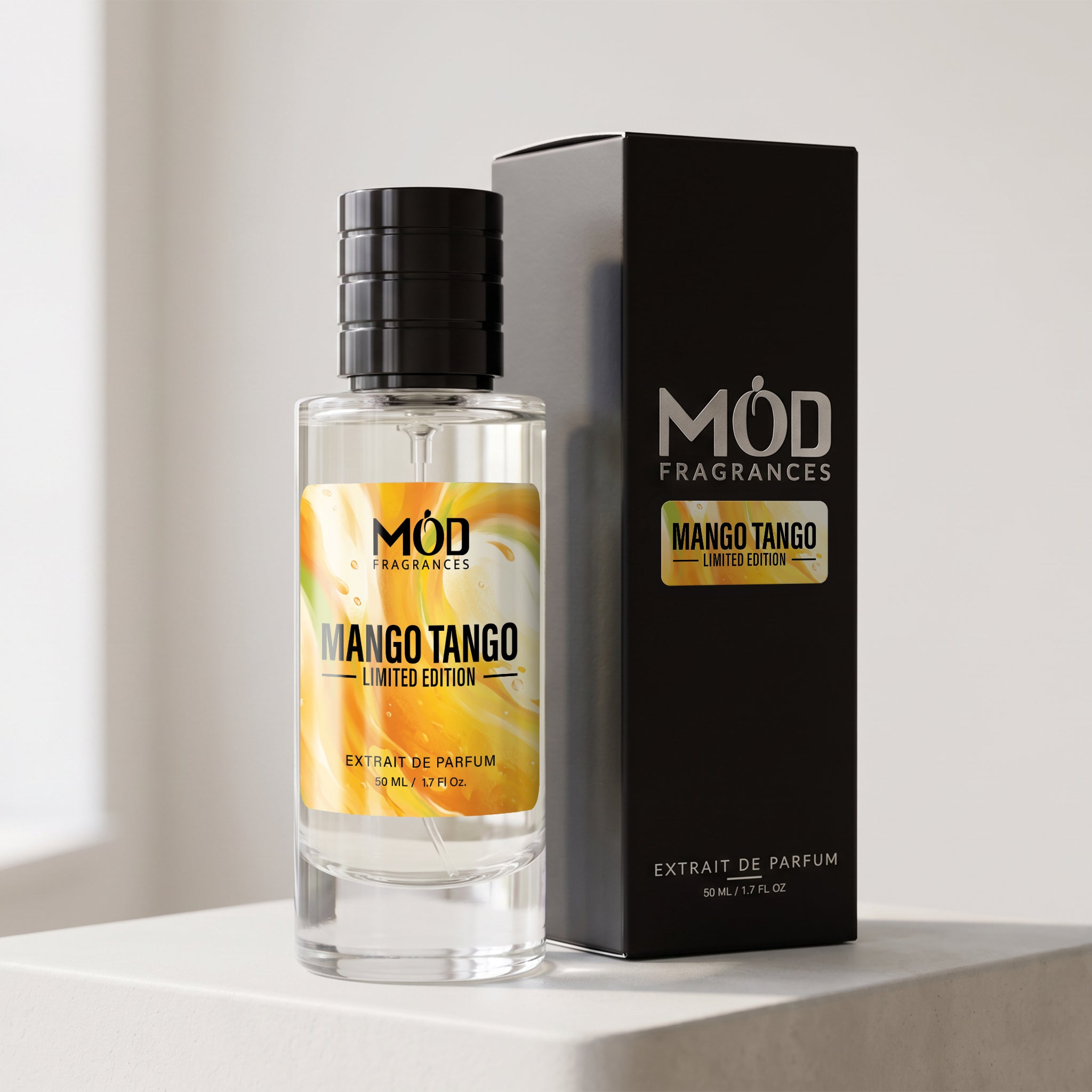 A bottle of MÓD Fragrances Mango Tango Limited Edition perfume next to its black packaging box, displayed on a clean white surface.
