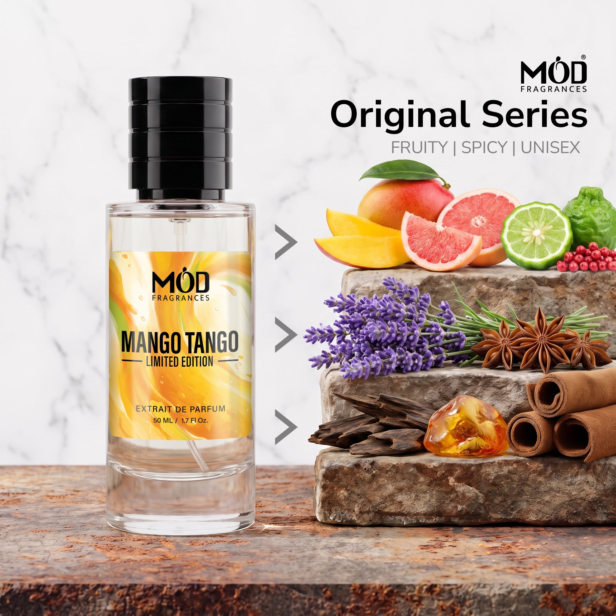 A bottle of MOD Fragrances Mango Tango Limited Edition extrait de parfum stands on a rustic wooden surface next to a stone block piled with scent-inspired ingredients including grapefruit, mango, lavender, star anise, cinnamon, and citrus. The background is a white marble texture with text reading 'Original Series FRUITY | SPICY | UNISEX' and the MOD Fragrances logo.