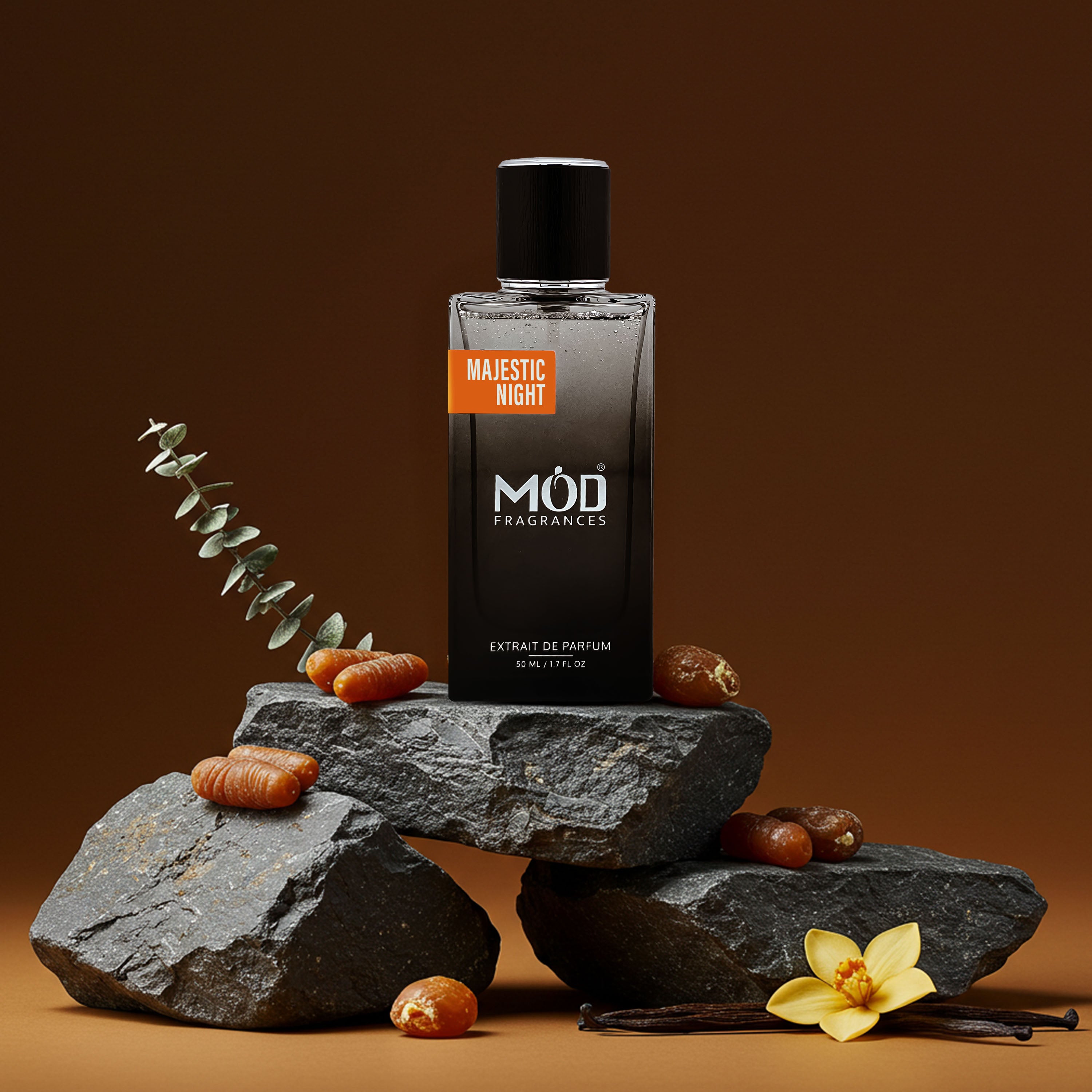 MUD Fragrances Majestic Night perfume bottle on rocks with vanilla beans and flowers on a brown background Grand Soir Dupe