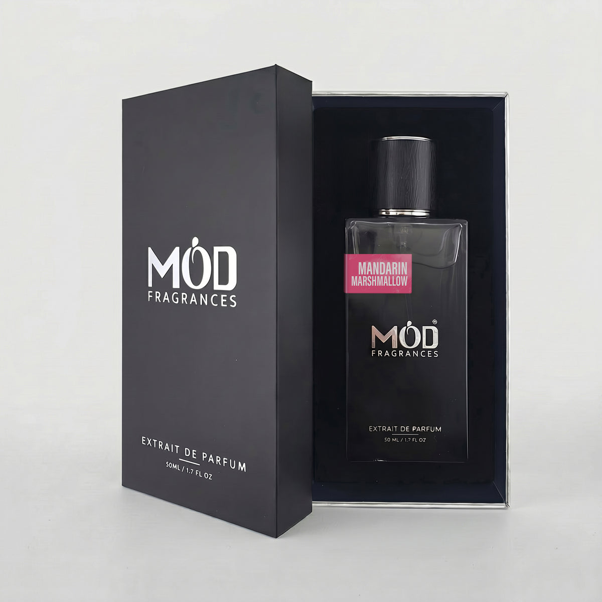 MOD Fragrances Extrait de Parfum bottle with a black cap, displayed next to its black packaging box. The bottle features a pink label reading 'Mandarin Marshmallow'.
