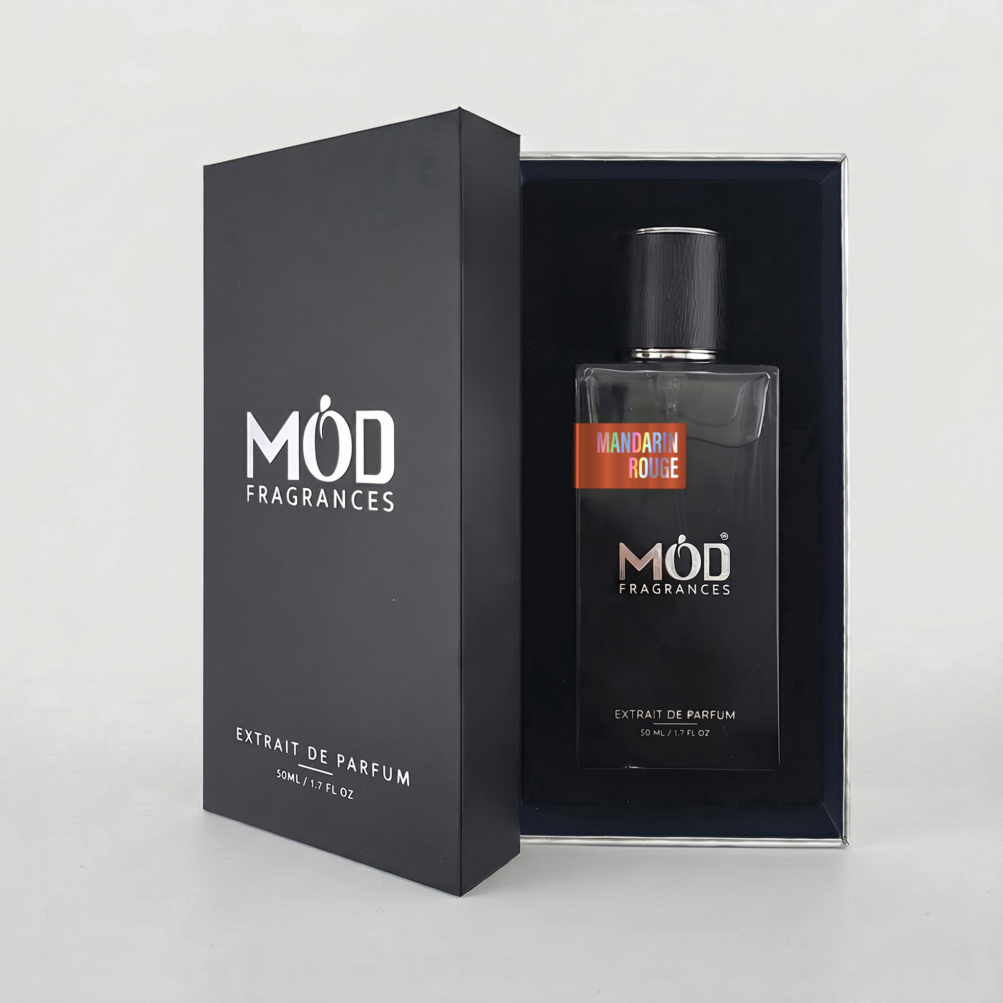 A bottle of MOD FRAGRANCES Extrait de Parfum in 'Mandarin Royale' scent, displayed next to its black outer packaging box on a light gray background.