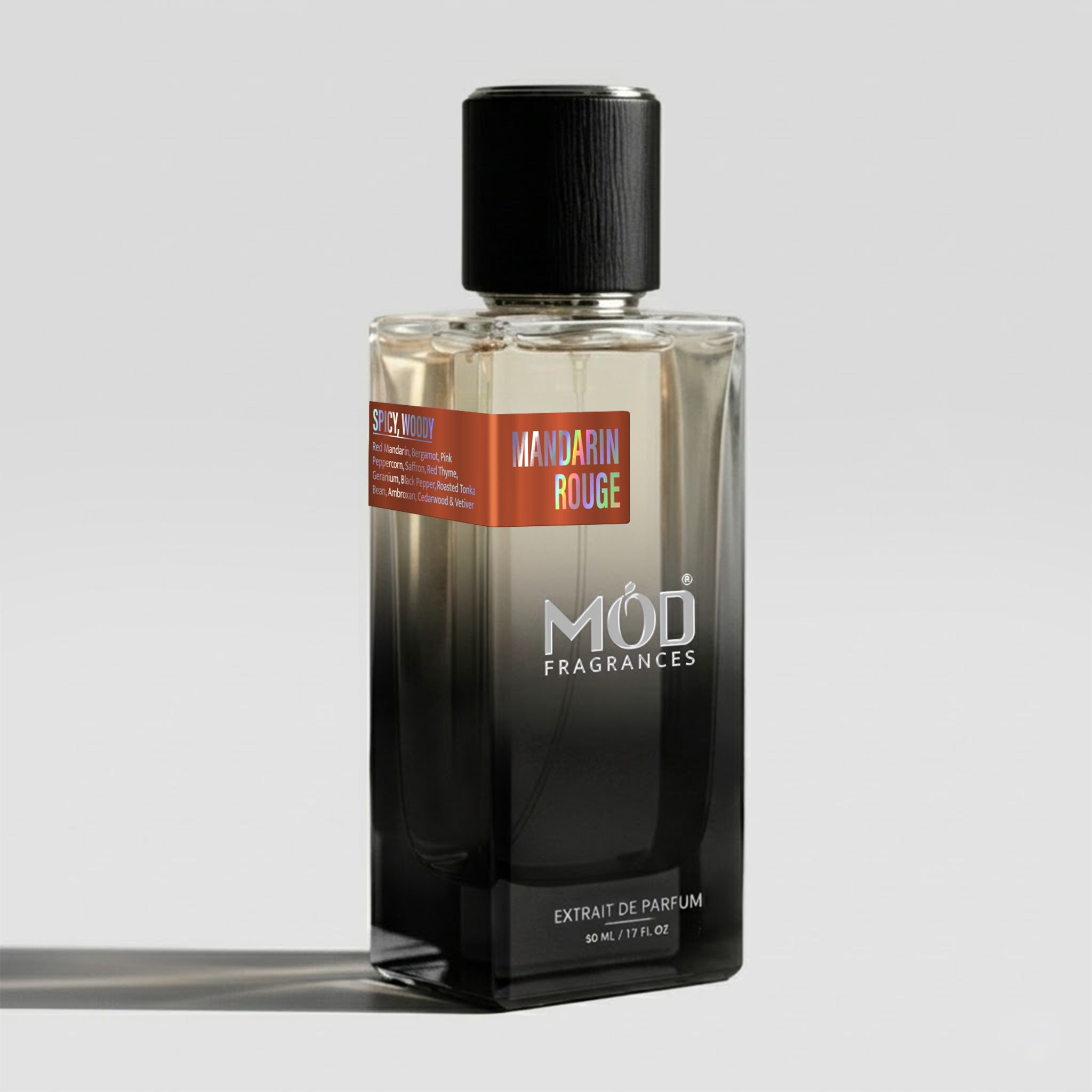 A bottle of MOD Fragrances Mandarin Rouge Extrait de Parfum, featuring a black-to-clear gradient glass bottle with a black cap and a red label, set against a light gray background.
