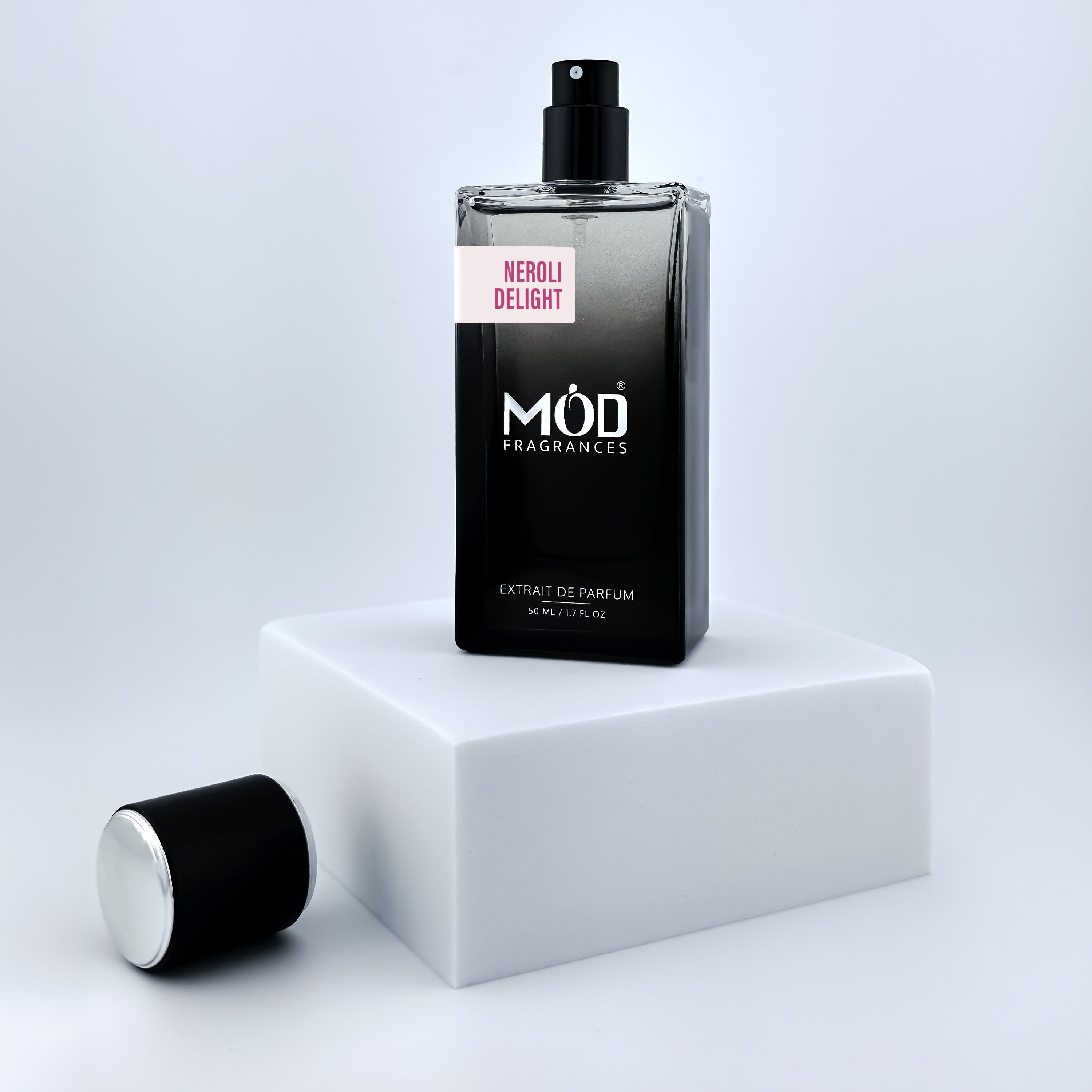 Perfume bottle labeled 'Möd Fragrances' on a white platform with a light gray background