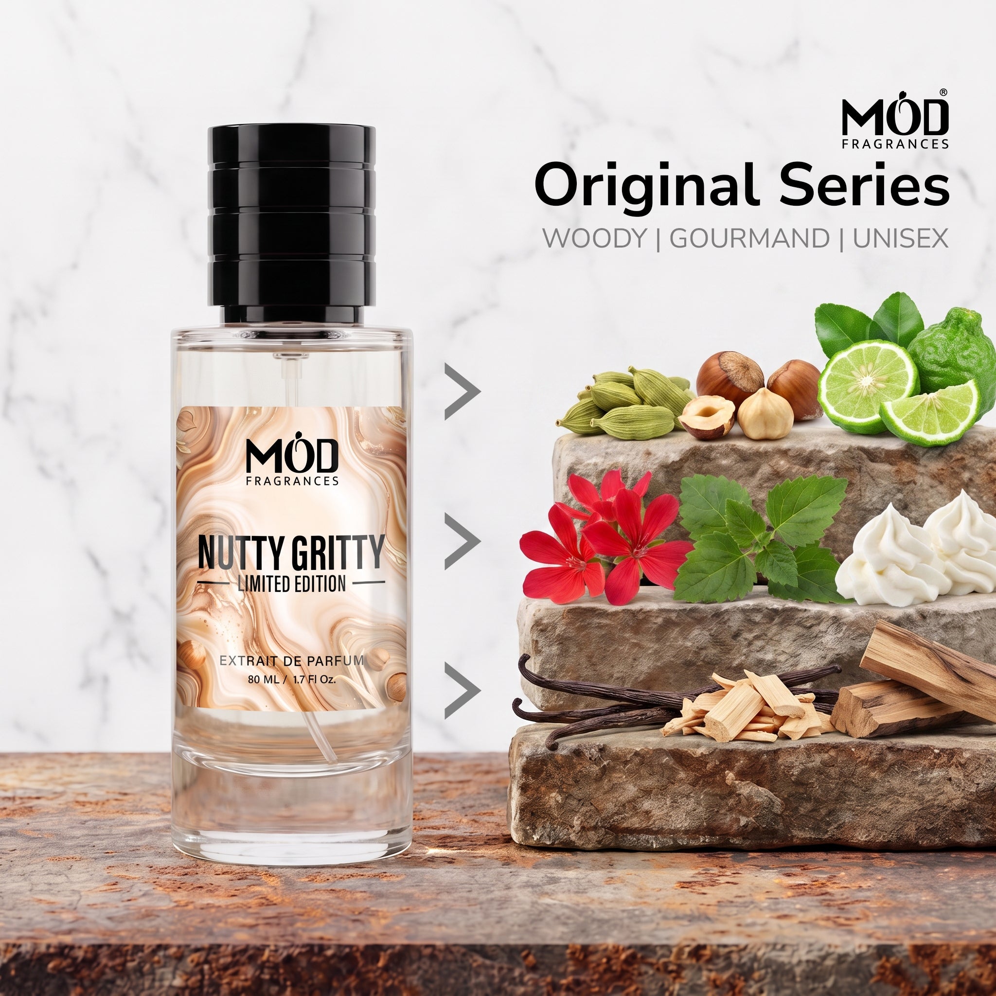 A bottle of MOD Fragrances 'Nutty Gritty' limited edition perfume stands on a rustic wooden surface next to a stone pedestal displaying its scent notes, including green pistachios, hazelnuts, lime slices, a red flower, vanilla cream, and wood pieces. The background is a white marble texture with text reading 'Original Series WOODY | GOURMAND | UNISEX'.