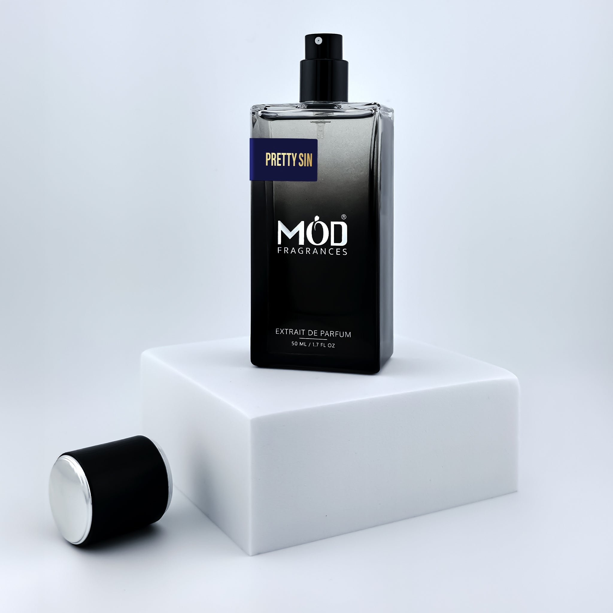 Perfume bottle labeled 'Möd Fragrances' on a white platform with a light gray background