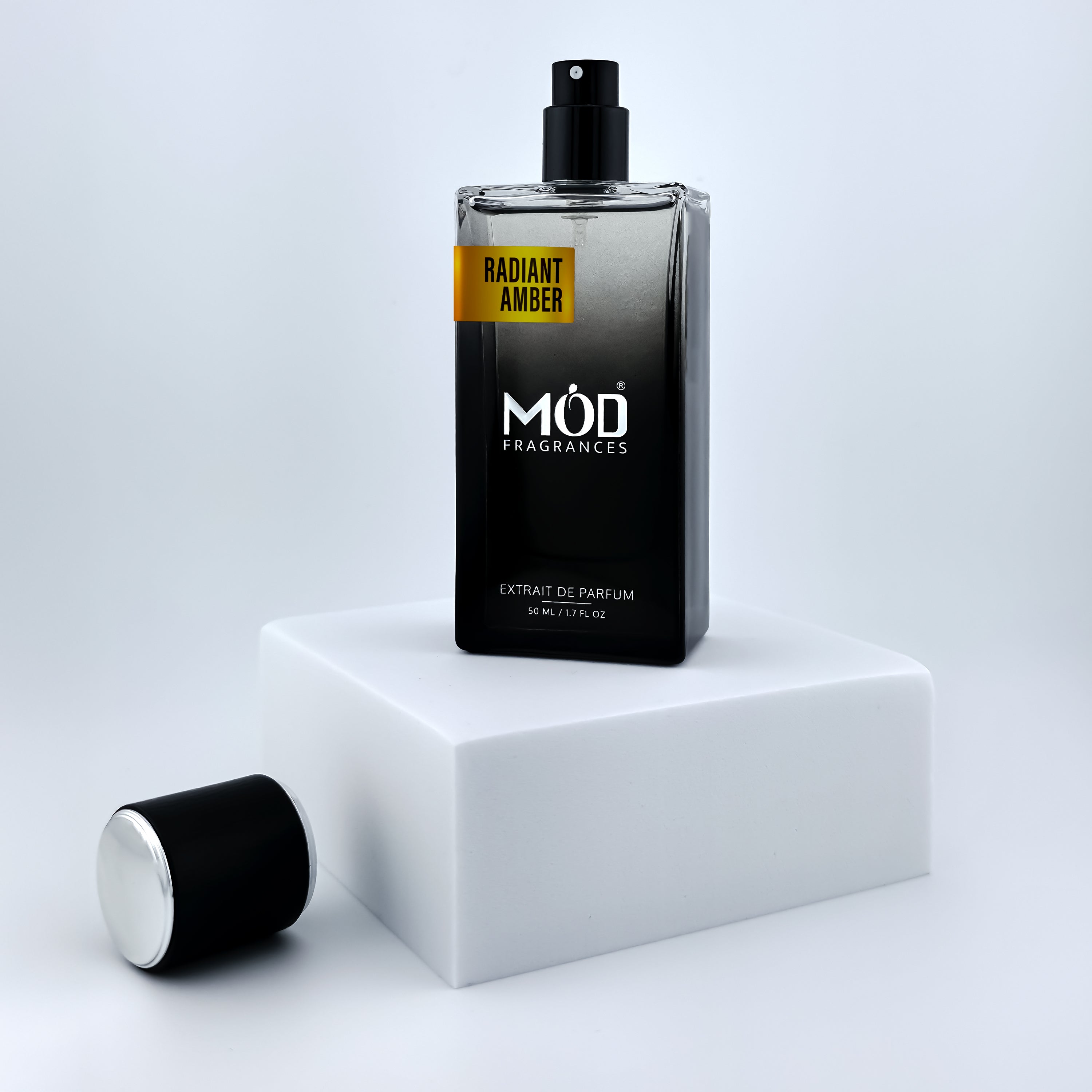 Perfume bottle labeled 'MOD Fragrances' on a white platform with a light gray background