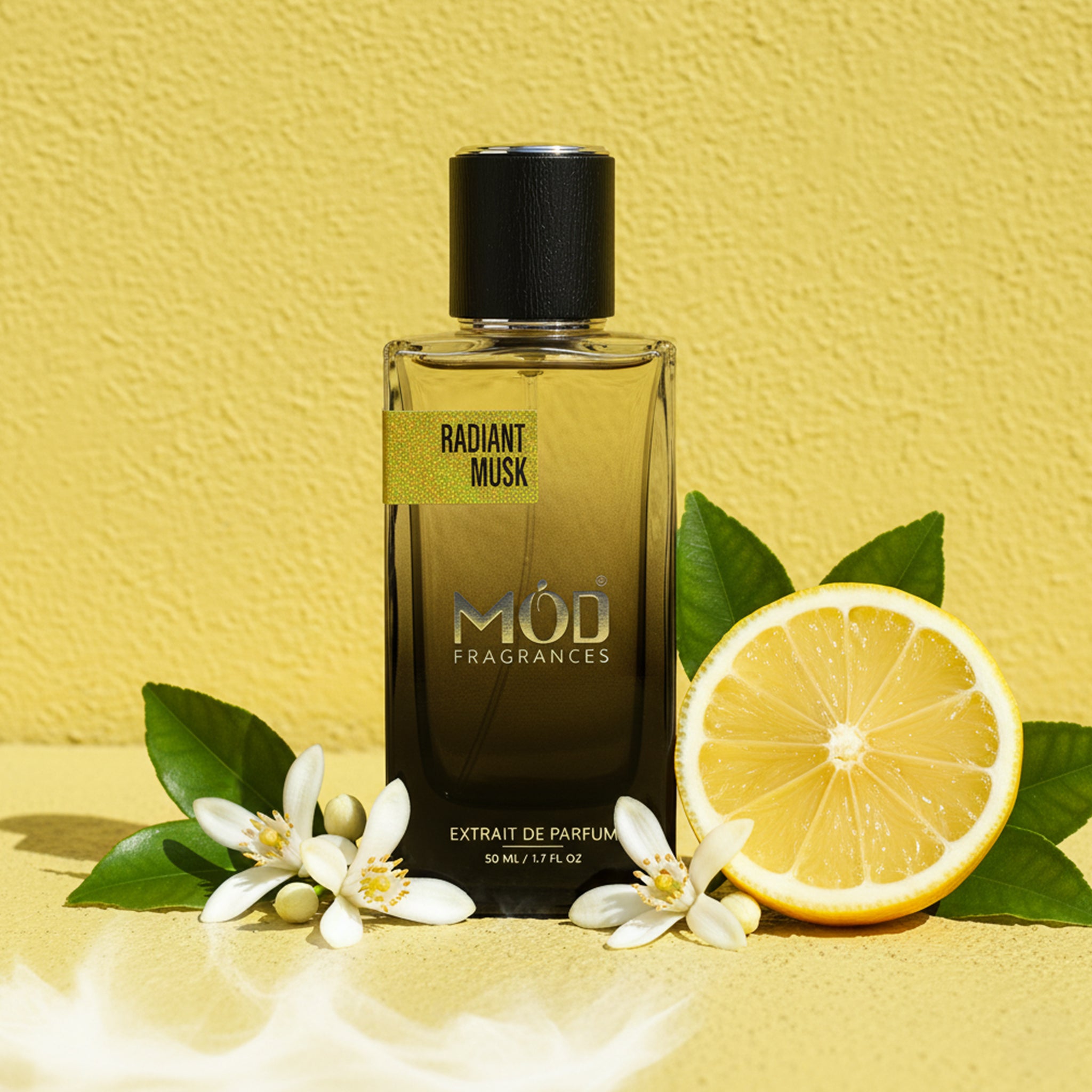 Perfume bottle labeled 'Radiant Musk' by MOD Fragrances with a lemon and flowers on a yellow background