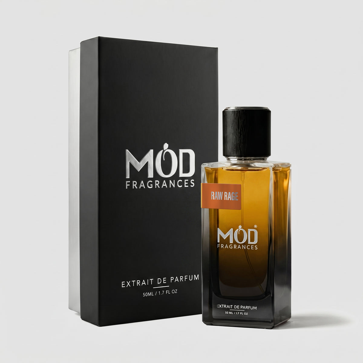 A rectangular perfume bottle by MOD Fragrances, labeled “Raw Rage” is positioned next to its closed, upright premium black display box on a light grey background.